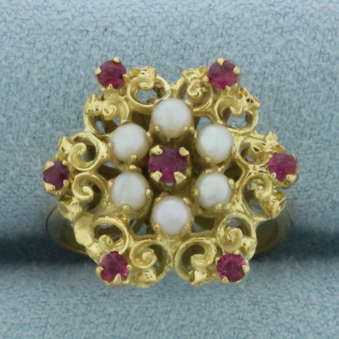 Ruby and Cultured Pearl Ring in 18k Yellow Gold: In 18k yellow gold. Measures 17mm wide at top of ring. Contains one 3mm and six 2mm high quality natural Ruby gemstones with bright color and excellent clarity. Also contains six high quality 3mm Cult