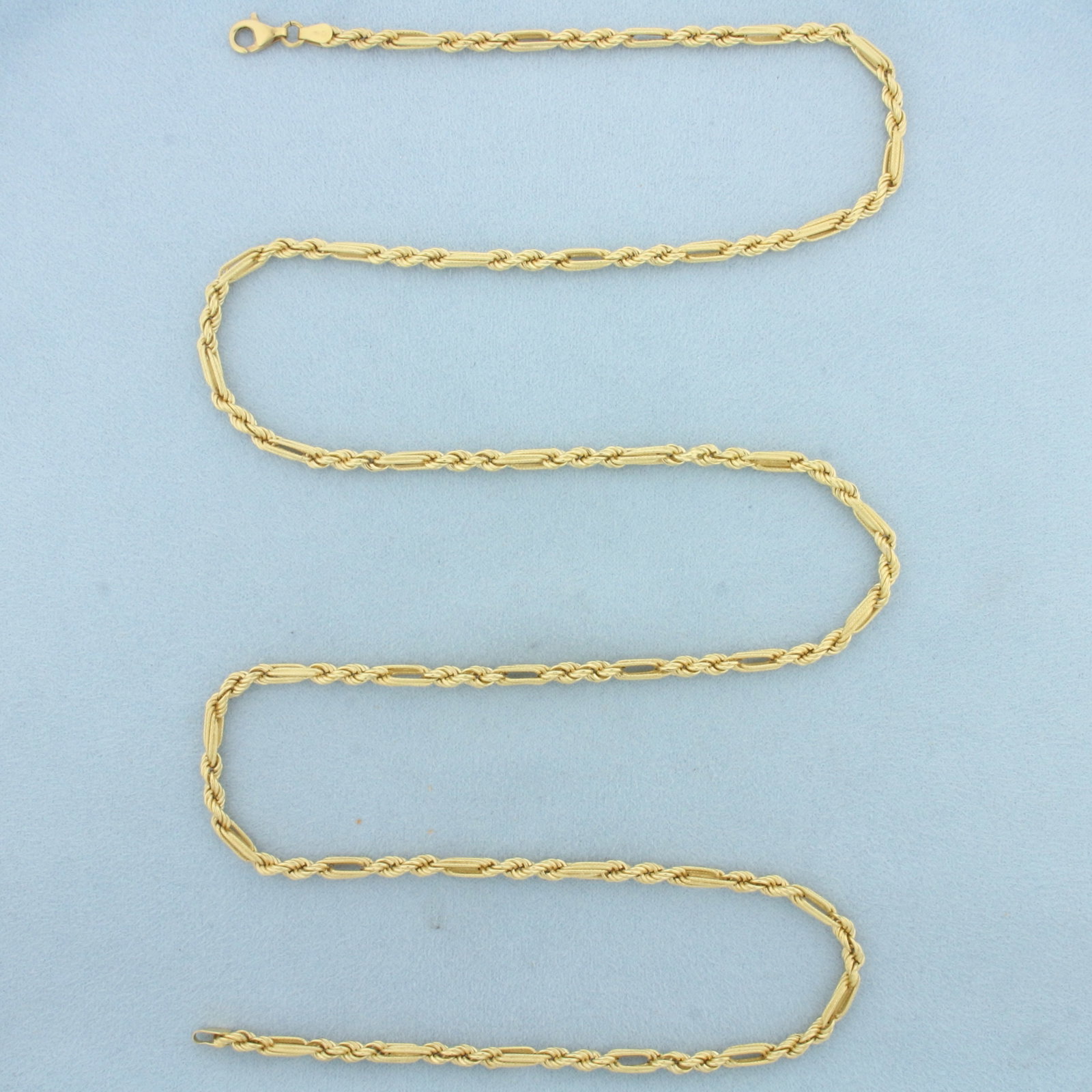 32 Inch Rope Figaro Link Chain Necklace in 18k Yellow Gold: In 18k Yellow Gold. 32 inches long. 3.2mm wide. Lobster clasp. 15.9g.