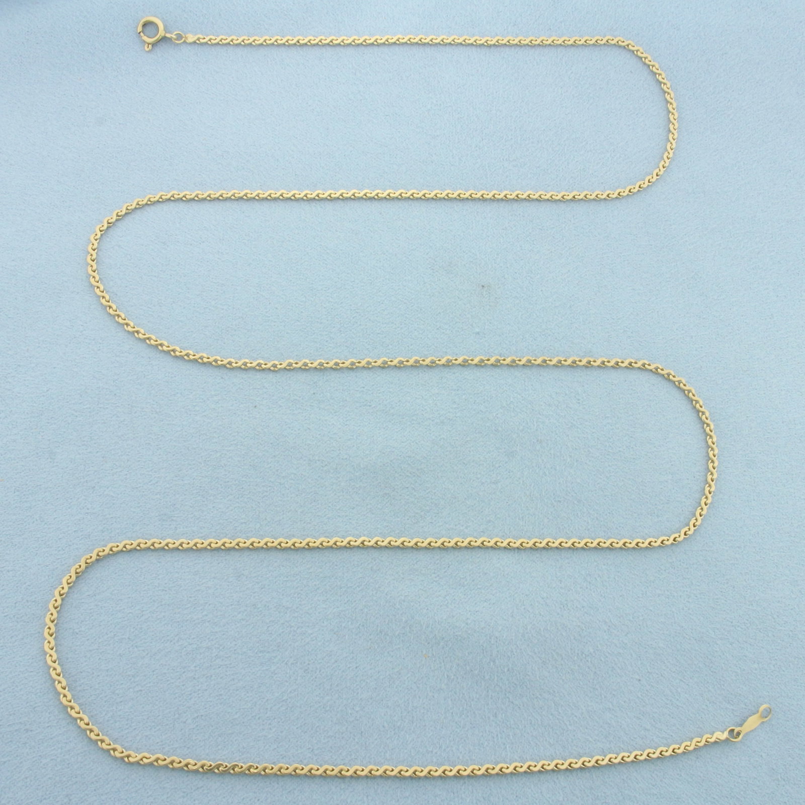 27 Inch Serpentine S-Link Chain Necklace in 14k Yellow Gold: In 14k Yellow Gold. 27 inches long. 2mm wide. Spring clasp. 9.3g.