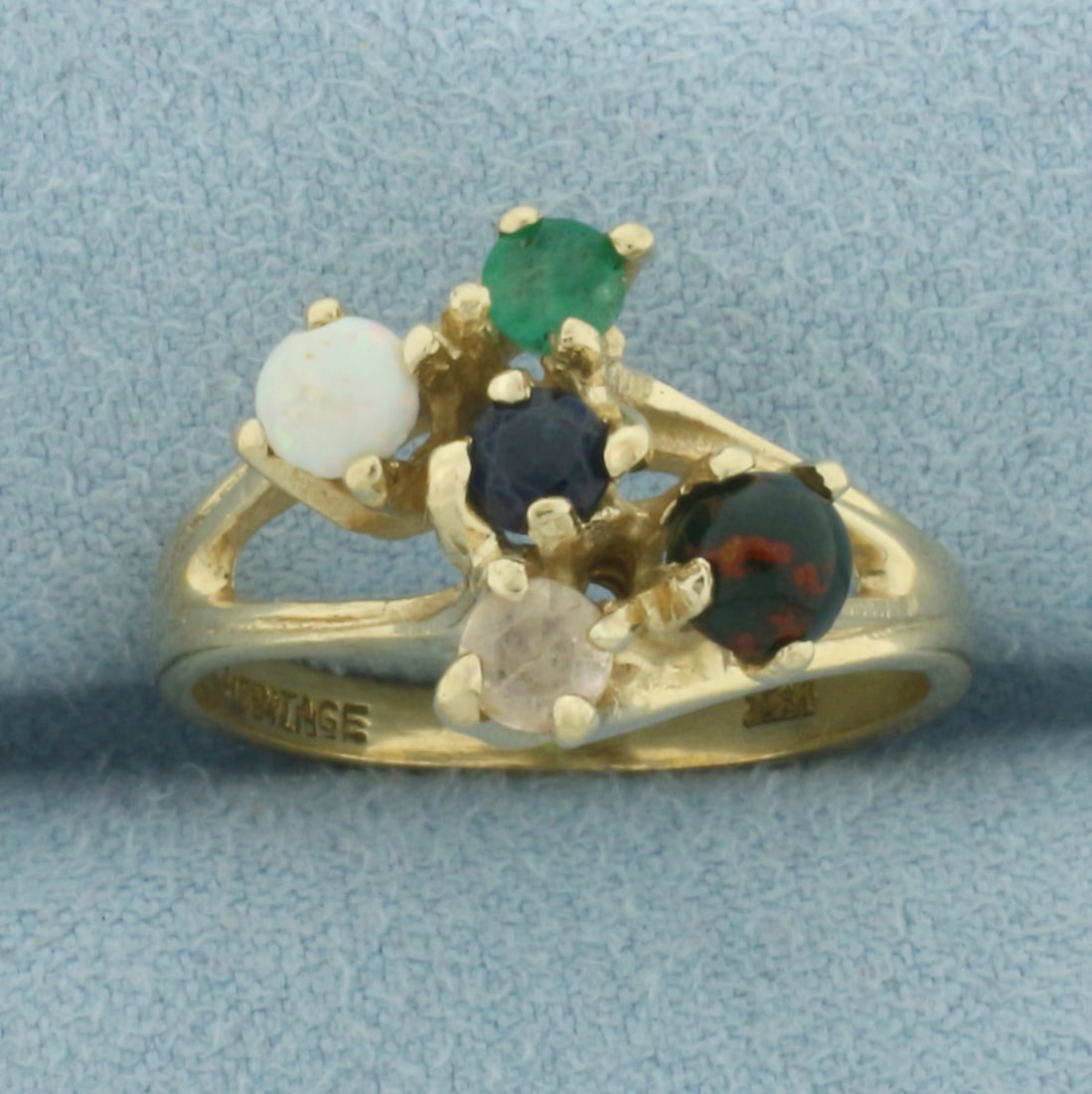Multi Gemstone Abstract Ring in 14k Yellow Gold: In 14k Yellow Gold. Contains multiple high quality natural gemstones including: one 4mm cabochon Opal, one 4.5mm cabochon Bloodstone, one 3.5mm Emerald, one 3.5mm Sapphire, and one 3.5mm White