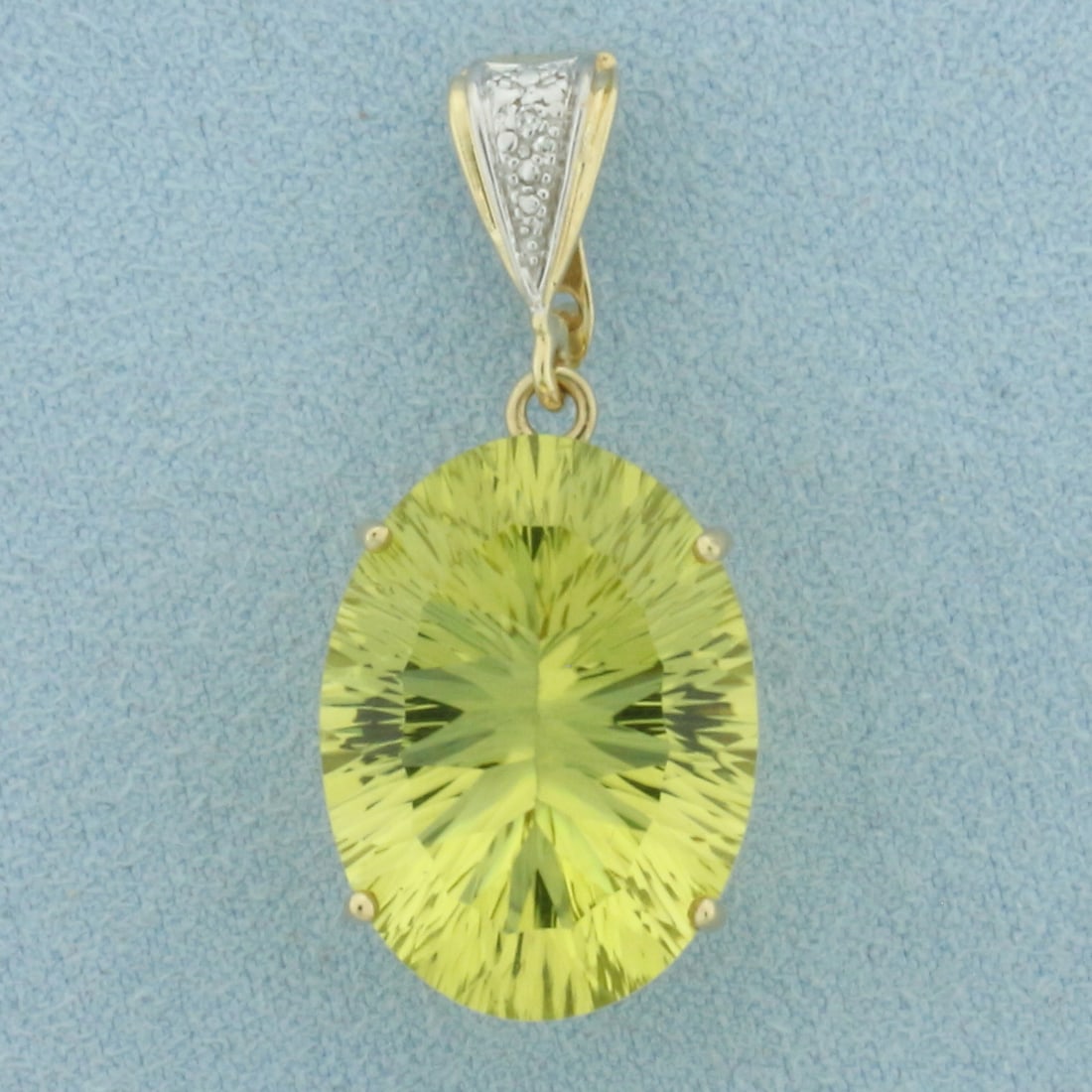 Fancy Cut Yellow Tourmaline and Diamond Pendant in 10k Yellow Gold: In 10k Yellow Gold. Contains one 20x15mm high quality oval fancy cut natural Yellow Tourmaline gemstone, approximately 16cts, with vibrant color and excellent clarity. Also contains one 1/2pt high qua