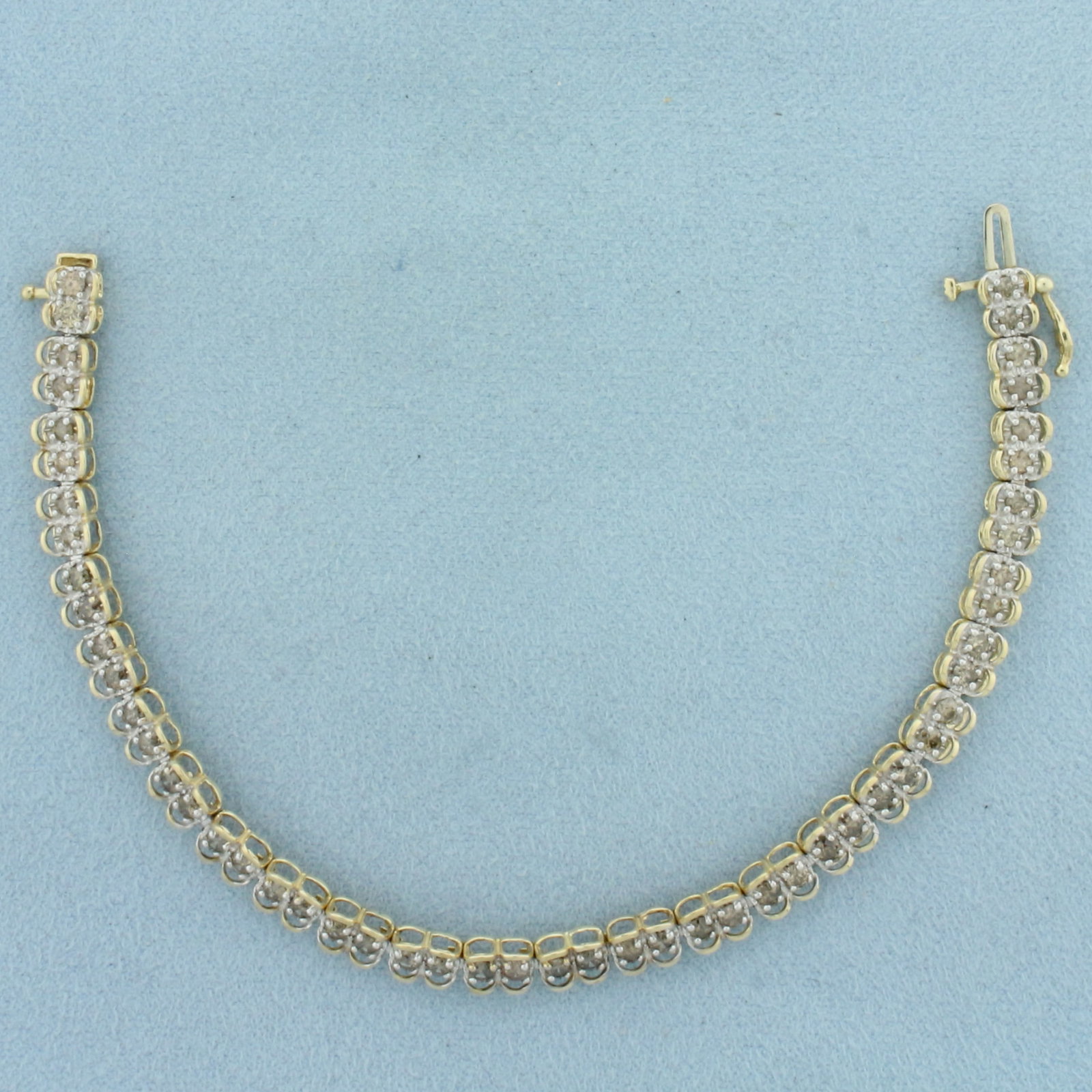 Champagne Diamond Tennis Bracelet in 10K Yellow Gold: In 10k yellow gold. 7 inches long, 5.2mm wide. Contains 52 high quality .05ct natural champagne diamonds with warm color. Concealed slide clasp with safety latch. 8.6g.
