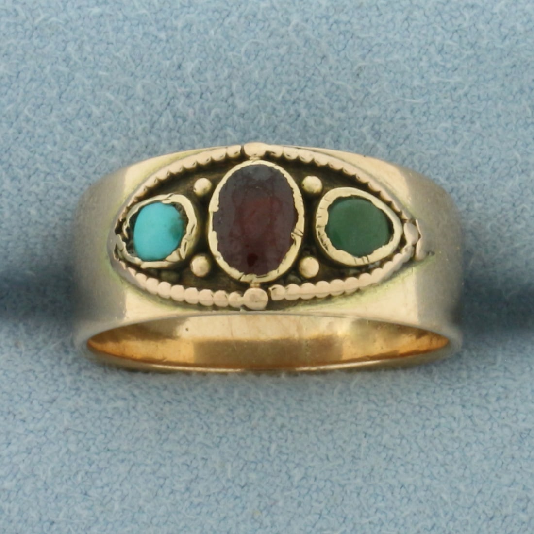 Desiger Numbered Garnet, Jade, and Persian Turquoise Ring in 14k Yellow Gold: In 14k Yellow Gold with Rose undertone. Contains one 6x4mm high quality oval cut natural Garnet gemstone with intense color. Also contains one 4x3mm high quality cabochon Jade gemstone with beautiful 