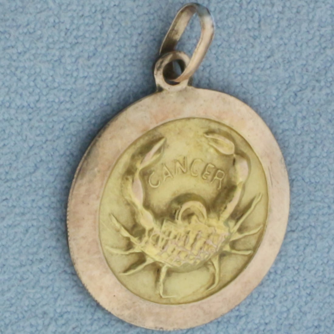 Cancer Zodiac Charm in 10k Yellow and Rose Gold: In 10k Yellow and Rose Gold. 3/4 inch long. 3/4 inch wide. 2.6g.