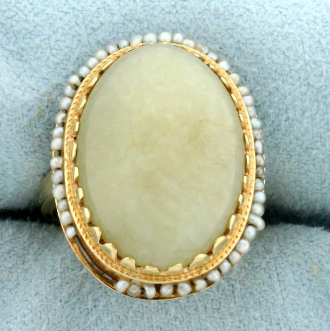 Antique Jade and Rotating Seed Pearl Ring in 14k Yellow Gold: In 14k yellow gold. Contains one oval high quality natural 18.4mm by 13.8mm Jade gemstone with light green color. Accented with small seed pearl beads that move along perimeter of ring on a wire. Size