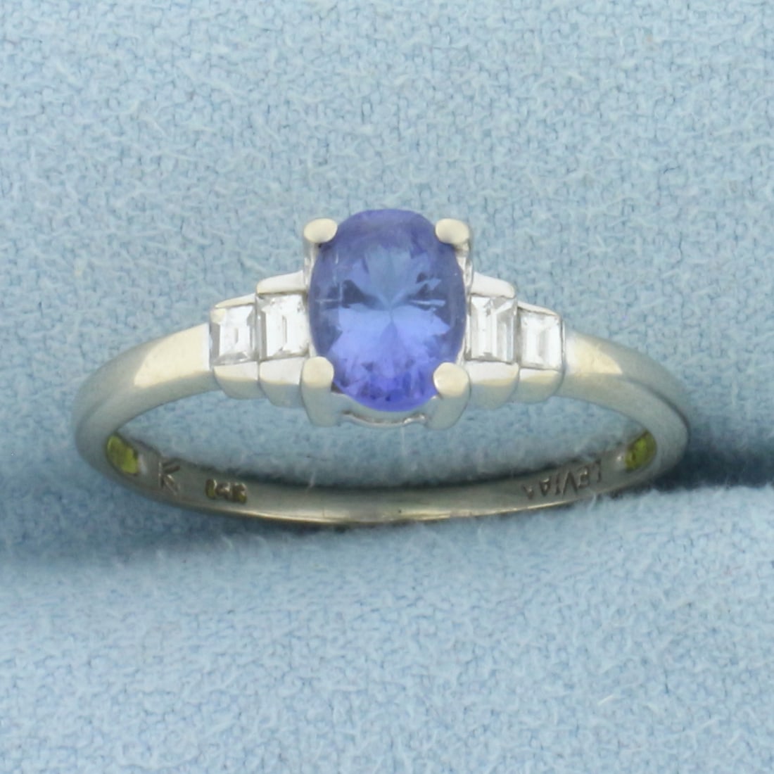 Levian Sapphire and Diamond Ring in 14k White Gold: In 14k white gold. Contains one high quality natural 5mm by 7mm Sapphire gemstone, 1ct, with bright color and excellent clarity. Also contains four rectangle step cut diamonds, 1/4ct TW, VS clarity/G 