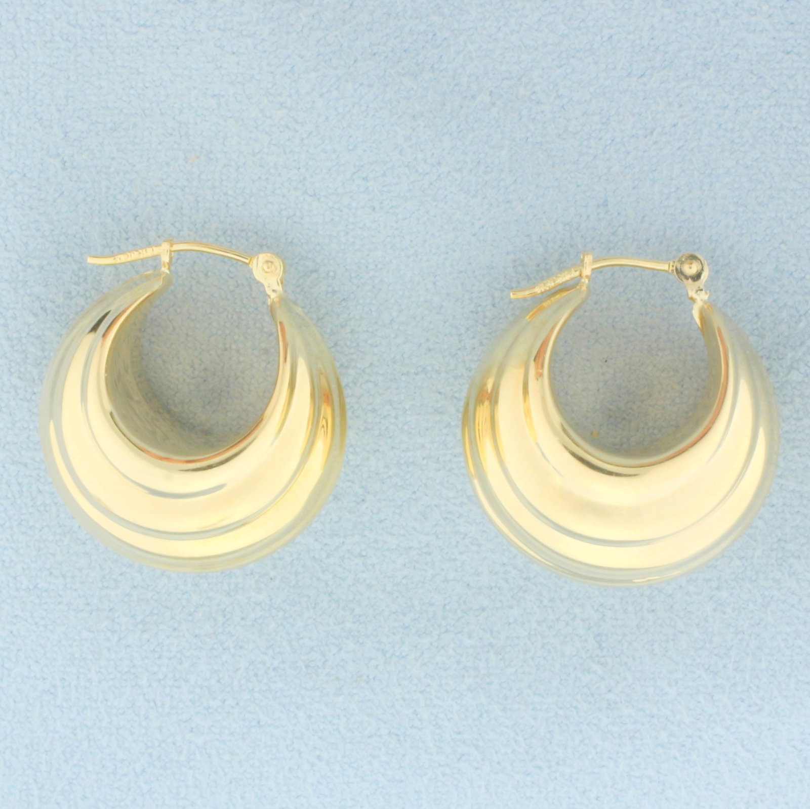 Wide Hoop Earrings in 14k Yellow Gold: In 14k Yellow Gold. 3/4 inch long. 14mm wide at widest point. 3.7g.