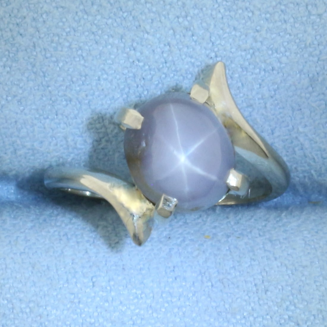 Grey Star Sapphire Ring in 14k White Gold: In 14k White Gold. Contains one high quality natural 8.5mmx7.5mm Star Sapphire gemstone with very distinct star under light. 14mm wide at widest. Size 4. 3.3g.