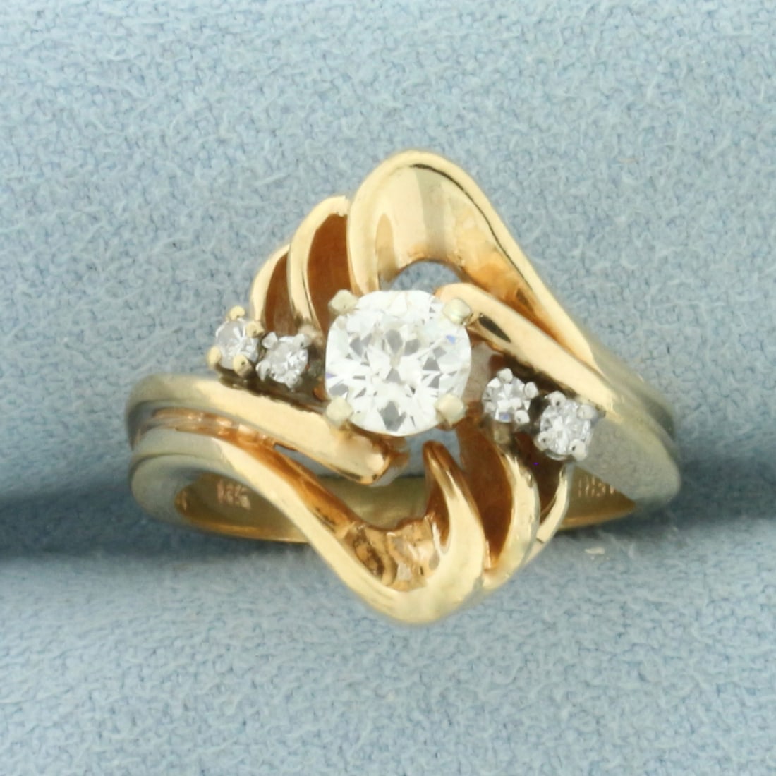 Antique Old Mine Cut Diamond Ring in 14k Yellow Gold: In 14k Yellow Gold. Contains one 1/2ct high quality Old Mine Cut diamond, VS clarity/I color. Also contains two .03ct and two .01ct single cut diamonds of similar high quality. 16.2mm wide at center. 