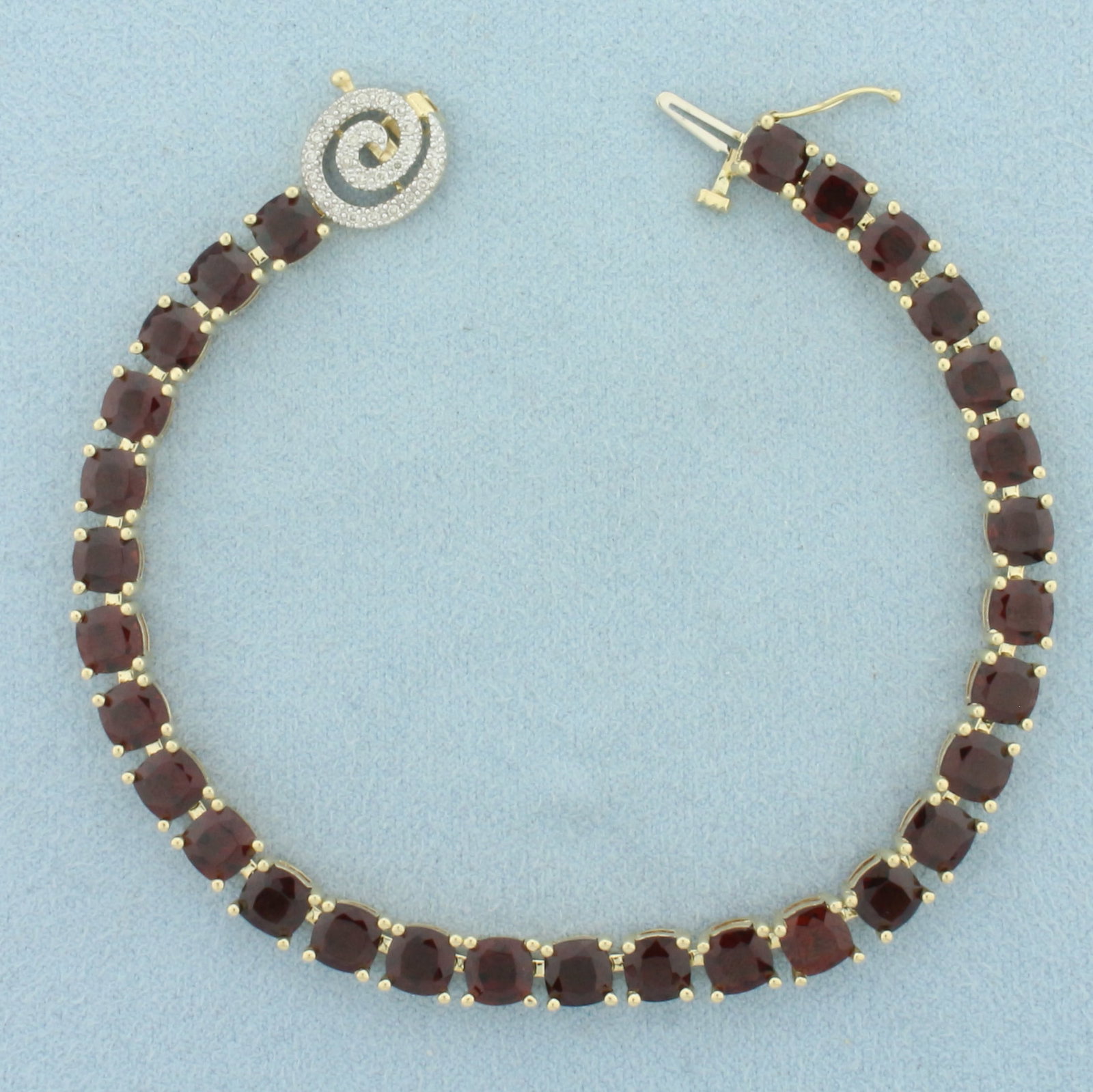 Garnet and Diamond Tennis Bracelet in 14k Yellow Gold: In 14k Yellow Gold. Contains thirty 5mm high quality natural Garnet gemstones, approximately 22ct TW, with deep color and excellent clarity. Also contains twenty-four 1/2pt high quality diamonds. 7.5 