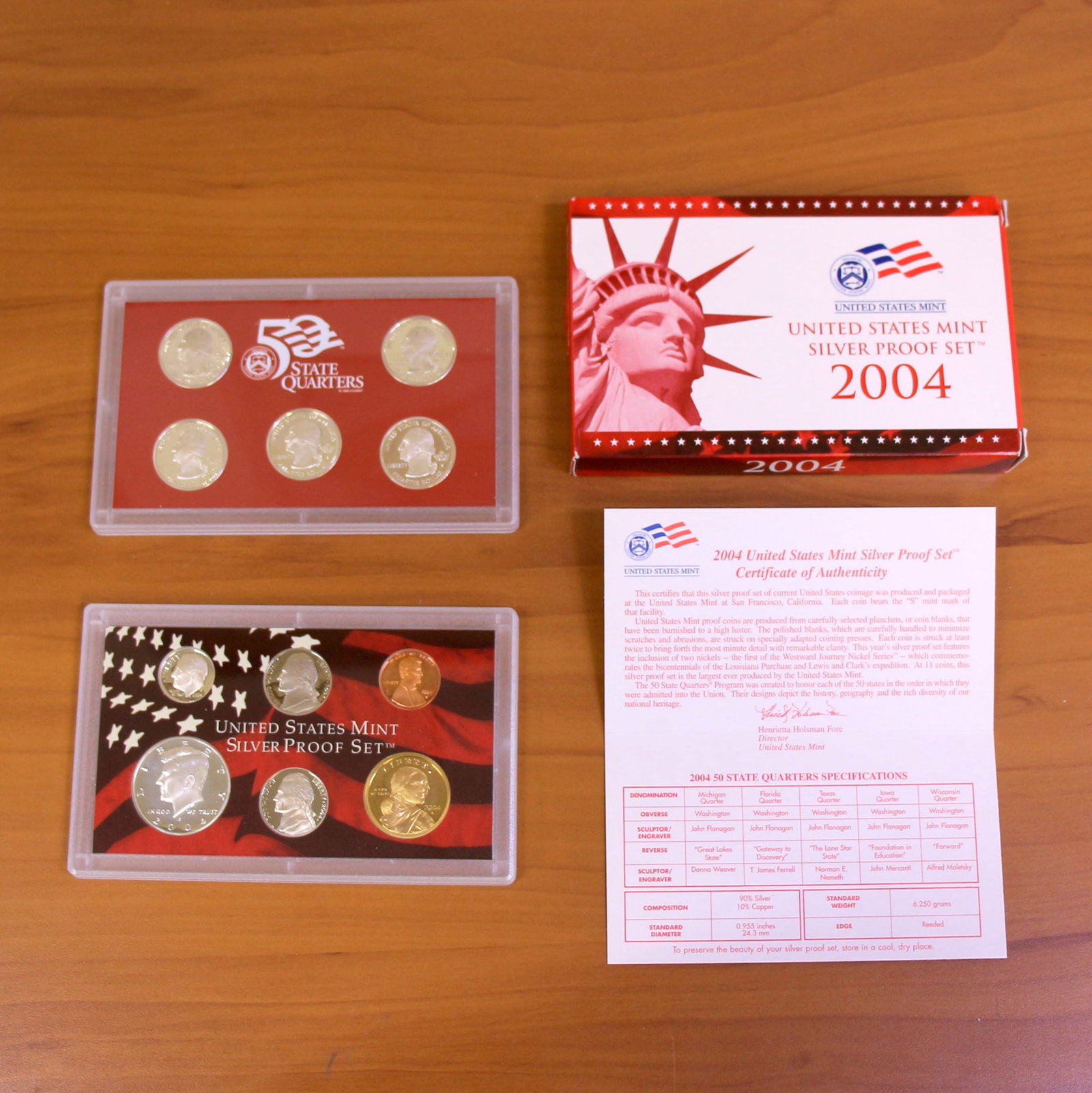 US Mint Silver Proof And Silver State Quarter Set: Contains one 2004 or 2006 United States Mint uncirculated silver proof set and United States Mint uncirculated state quarters coin set. Set in original government packaging, box, and certificate of