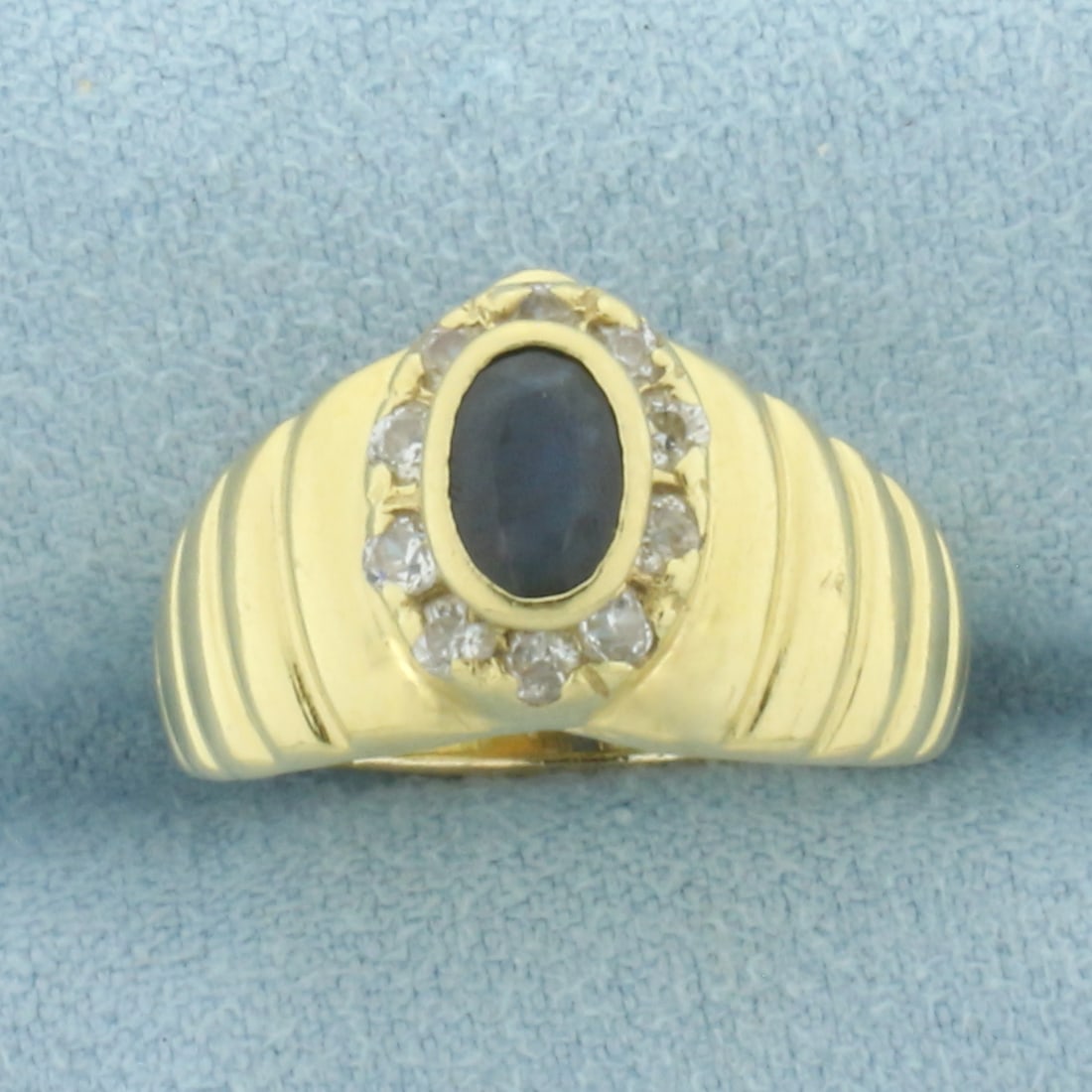 Italian Sapphire and Diamond Ring in 18k Yellow Gold: In 18k Yellow Gold. Contains one 6x4mm high quality natural Sapphire gemstone with intense color and excellent clarity. Also contains ten .02ct high quality diamonds, VS clarity/F color. 11mm wide at