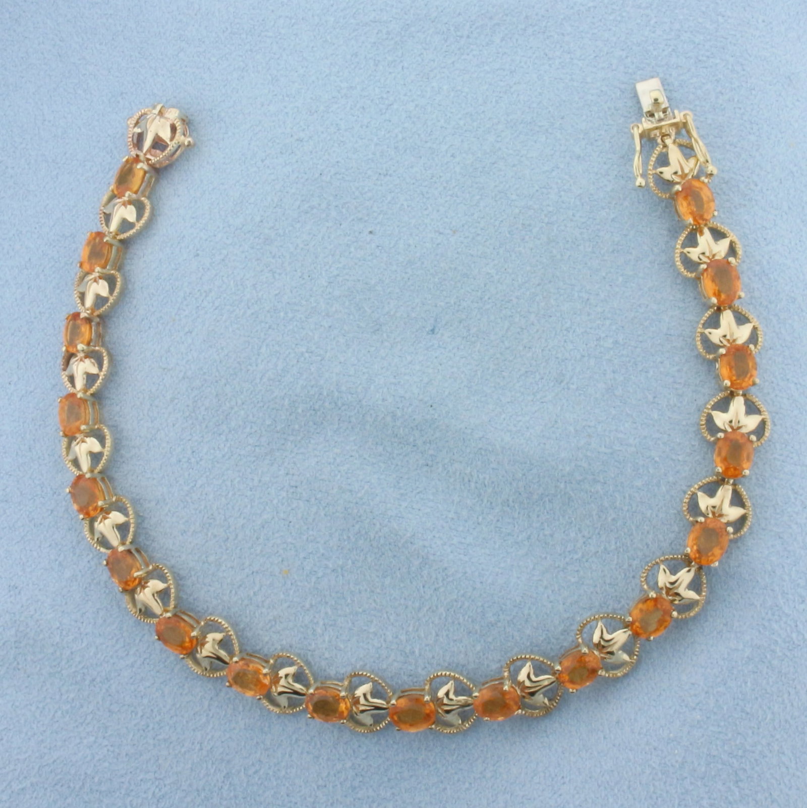 Citrine Tennis Bracelet in 10K Yellow Gold: In 10k yellow gold. Contains eighteen 5mm high quality natural Citrine gemstones, approximately 4.5ct TW, with bright color and excellent clarity. 7 inches long by 7.3mm wide. Slide clasp with safety 