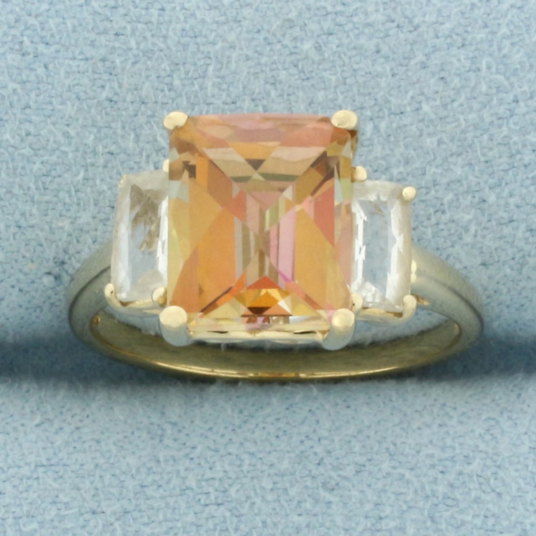 Mystic Topaz Ring in 10k Yellow Gold: In 10k Yellow Gold. Contains one 10mm high quality checkerboard cut Mystic Topaz gemstone with intense color and excellent clarity. Also contains two 6mm high quality checkerboard cut natural White To