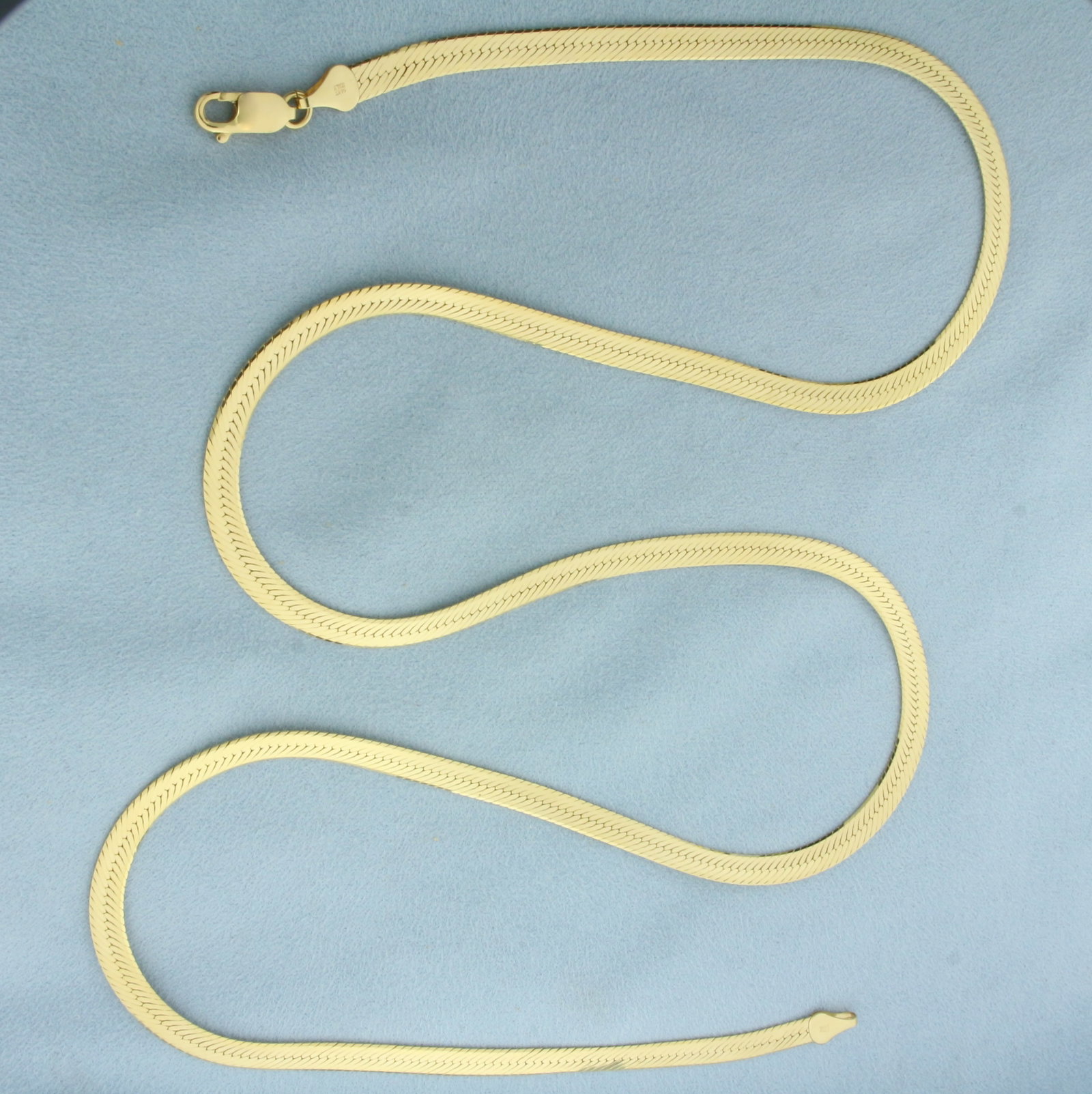 30 Inch Italian Herringbone Link Chain Necklace in 14K Yellow Gold: In 14k yellow gold. Italian made. Measures 30 inches long by 5mm wide. High polish finish. Lobster clasp. 27.1g