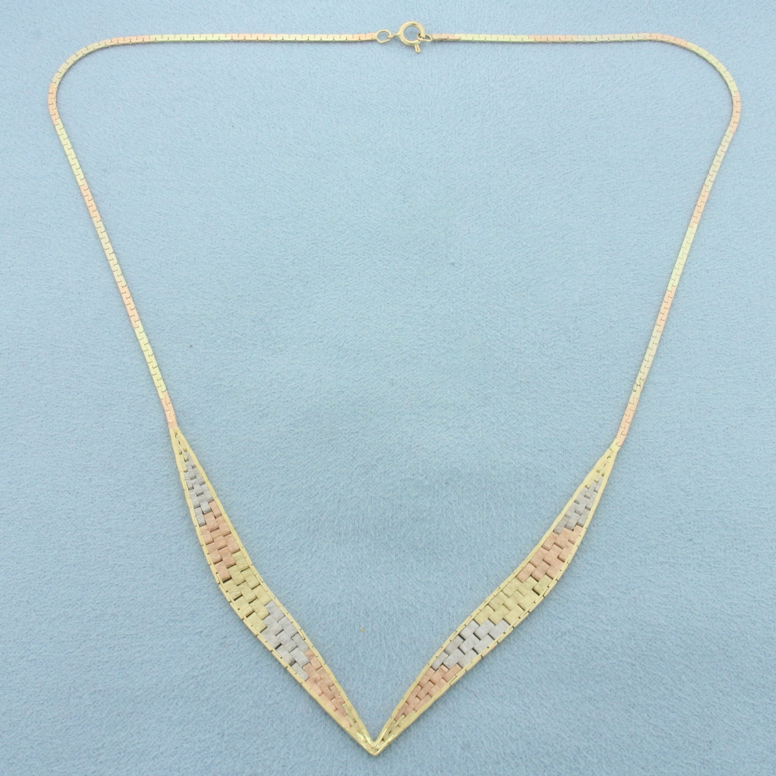 Tri-Color V Style Choker Necklace in 14k Yellow, White, and Rose Gold: In 14k Yellow, White, and Rose Gold. 16 inches long. 6.2mm wide at widest point. Spring clasp. 7.6g.