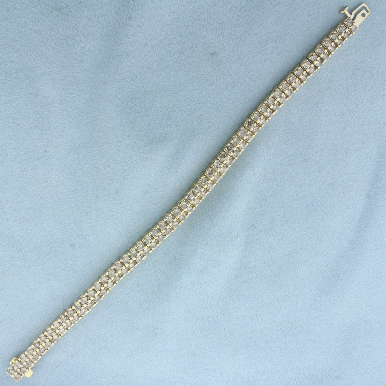 Diamond Tennis Bracelet in 10k Yellow Gold: In 10k Yellow Gold. Contains one hundred high quality .08ct diamonds, 8ct TW, I color/I clarity. 7 inches long. 1/4 inch wide. Concealed slide clasp with underswing safety latch. 25.5g.