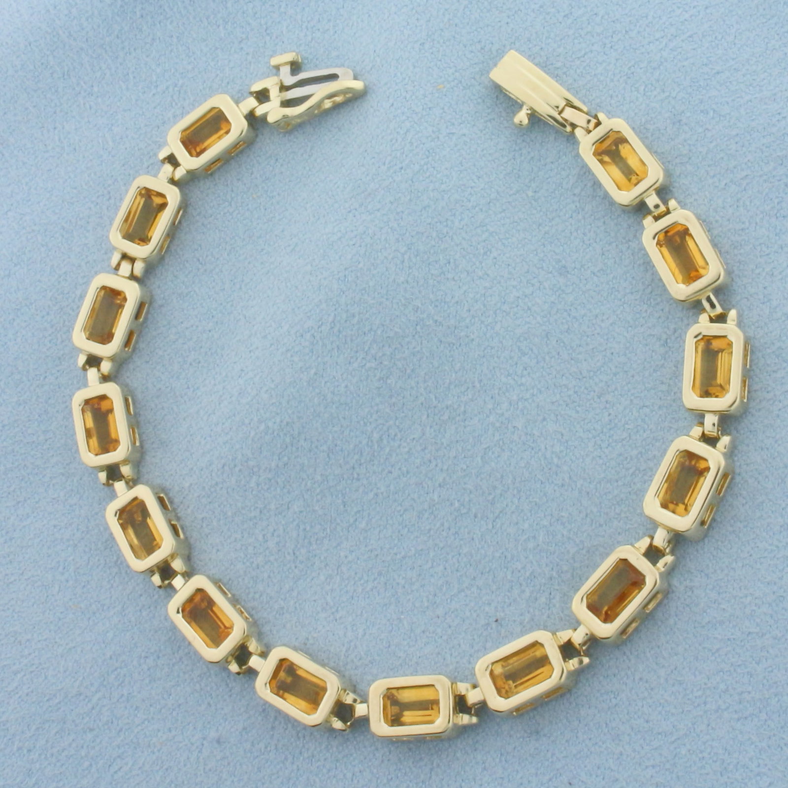 Citrine Bezel Set Tennis Bracelet in 14k Yellow Gold: In 14k Yellow Gold. 6 7/8 inches long. 1/4 inch wide. Contains 14 high quality natural 7mm emerald cut citrine gemstones, 1 carat each, 14 carats total weight, with bright color and excellent clarity.