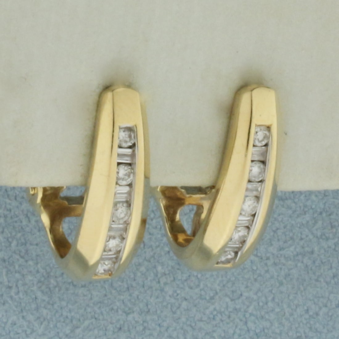 Diamond J-Hoop Earrings in 14k Yellow Gold: In 14k Yellow Gold. Contains ten round and eight baguette high quality diamonds, 1/3ct TW, VS clarity/G color. 5/8 inch long. 3/8 inch wide (profile). Omega backs. 4.5g.