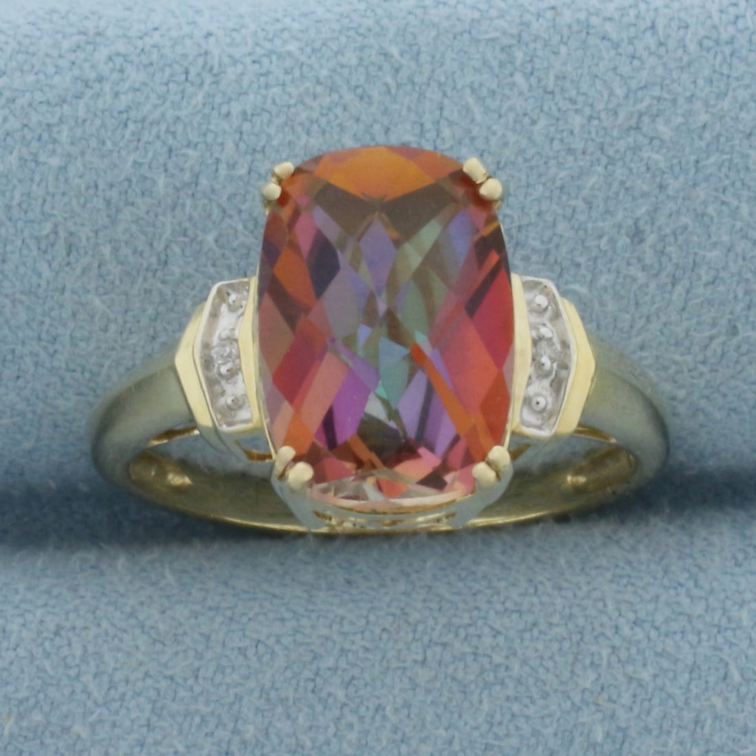 Checkerboard Mystic Topaz and Diamond Ring in 10k Yellow Gold: In 10k Yellow Gold. Contains one 13x9mm high quality fancy checkerboard cut Mystic Topaz gemstone with vibrant color and excellent clarity. Also contains two high quality 1/2pt diamonds. Size 9. 3.9g.