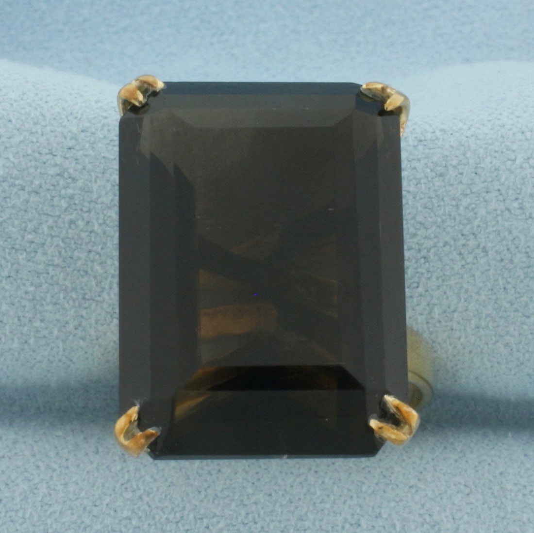 Smoky Topaz Statement Ring in 18k Yellow Gold: In 18k Yellow Gold. Contains one 24x17x10mm high quality natural Smoky Topaz gemstone, approximately 23cts, with intense color and excellent clarity. Size 6.75. 10.2g.