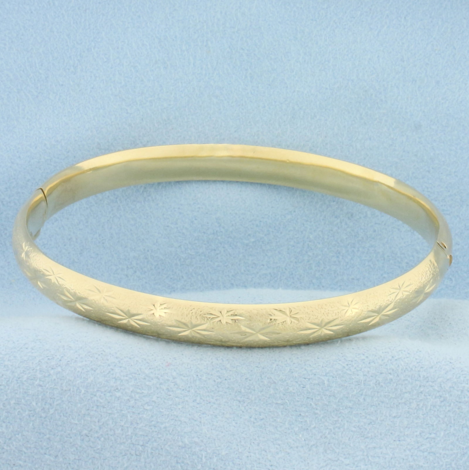 Star Design Bangle Bracelet in 14k Yellow Gold: 14k yellow gold. 2 1/4 inch inner diameter. 6.25mm wide. 10.2g.