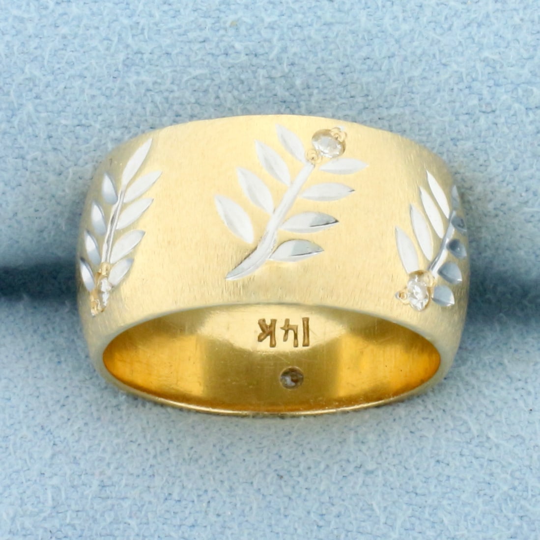 Leaf Nature Design Diamond Band Ring in 14k Yellow Gold: In 14k yellow and white gold . Contains seven high quality .01ct diamonds, SI clarity/G color. 9.9mm wide. Size 7. 9.2g.
