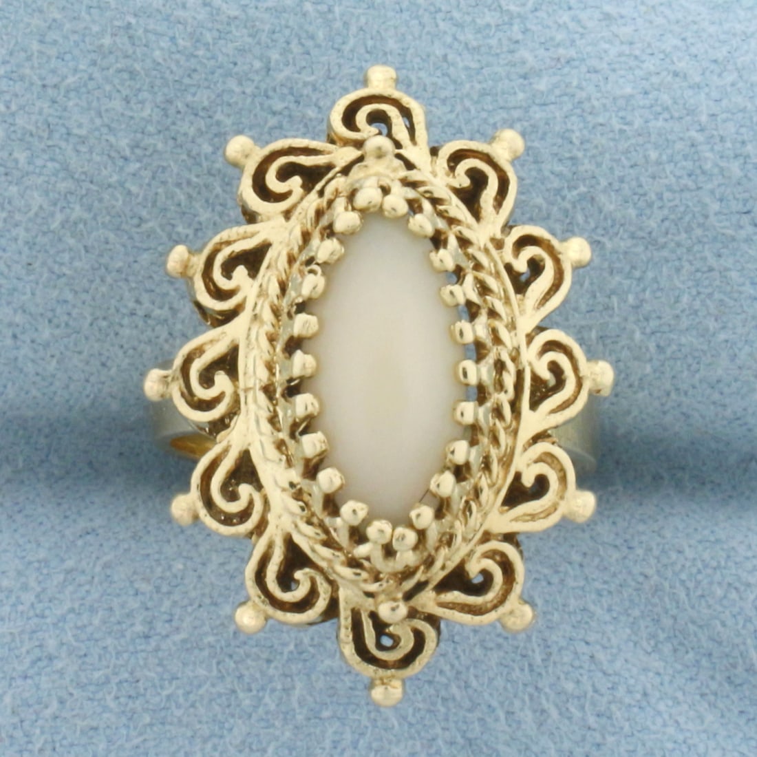 Vintage Coral Ring in 14k Yellow Gold: In 14k Yellow Gold. Contains one 15x6.5mm high quality Coral gemstone. 1 inch wide at center of ring. Size 7. 6.5g.