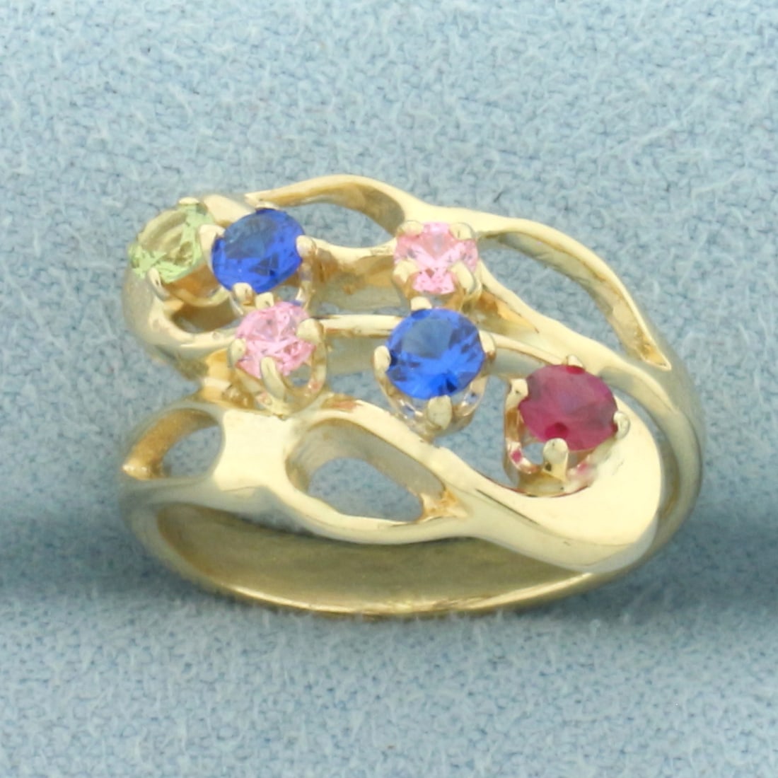 Rainbow Topaz Ring in 14k Yellow Gold: In 14k Yellow Gold. Contains 3mm high quality natural Topaz gemstones in blue, red, pink, and yellow - all bright color and excellent clarity. 14mm wide spread at top of ring. Size 5.5. 4.5g.