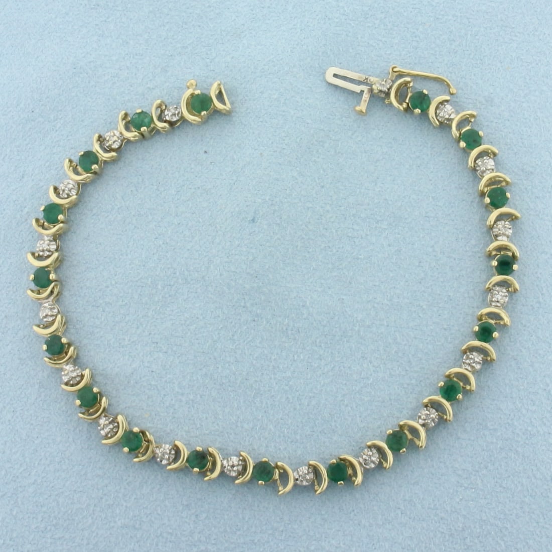 Emerald and Diamond Tennis Bracelet in 10K Yellow Gold: In 10k yellow gold. Measures 7.25 inches long. Contains 18 high quality natural 3.3mm Emerald gemstones, approximately 2.5ct TW, with intense color. Also contains 18 high quality 1/2pt diamonds. Conce