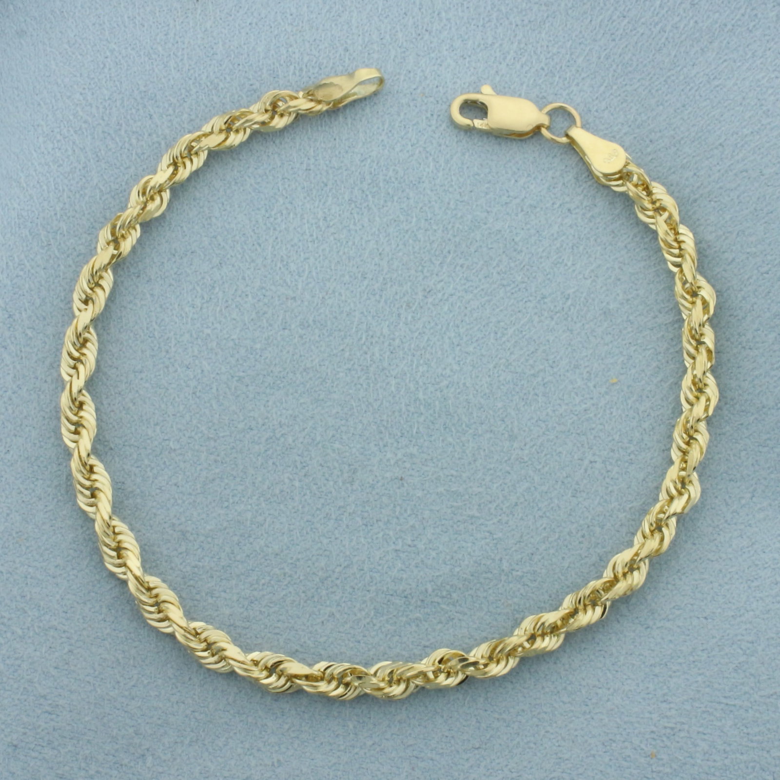 Rope Bracelet in 14k Yellow Gold: In 14k Yellow Gold. 7 3/8 inches long. 4mm wide. Lobster clasp. 7.8g.