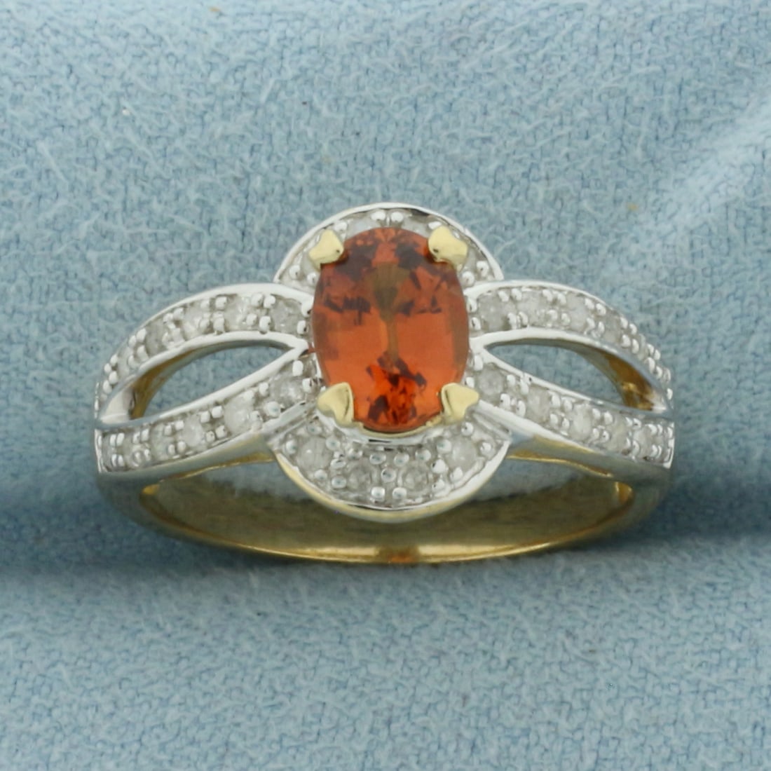Spessartite Garnet and Diamond Ring in 10K Yellow Gold.: In 10K Yellow Gold. 11.3mm wide at top of ring. Contains one high quality 7mm natural oval cut Spessartite Garnet, approximately 1ct, with vibrant color and excellent clarity. Also contains thirty-two