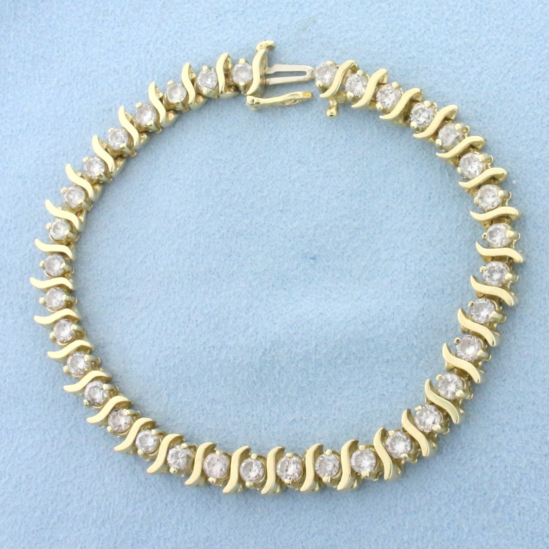 5ct Diamond Tennis Bracelet in 14k Yellow Gold: In 14k yellow gold. Contains 35 round brilliant diamonds, 5ct TW, I color/I clarity, great cut for lots of sparkle. 7 inches long, 6.3mm wide. Safety clasp. 15.2g.