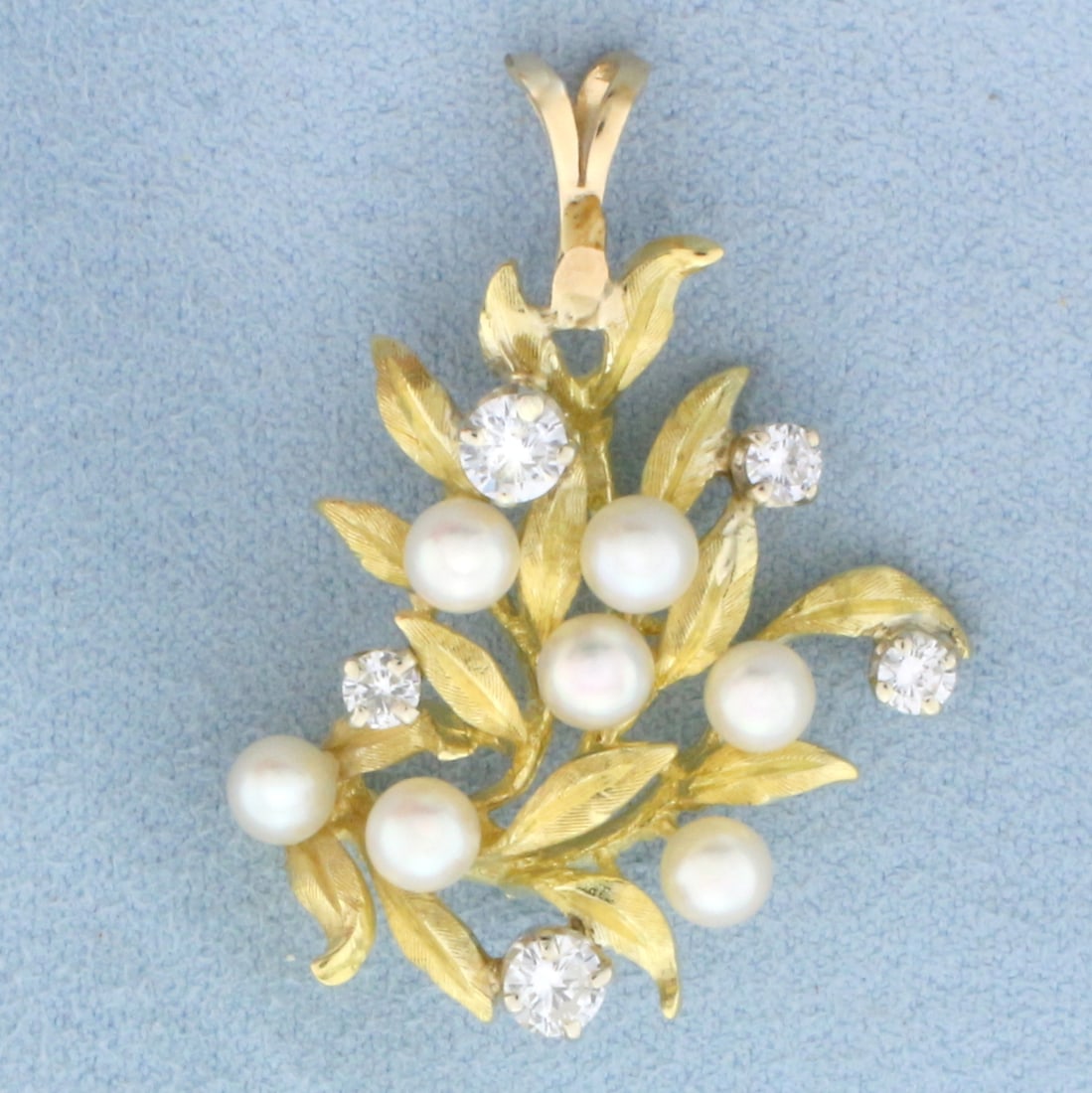 Diamond and Pearl Leaf Nature Design Pendant in 18k Yellow Gold: In 18k yellow gold. Contains one .3ct, one .25ct, two .1ct, and one .05ct high quality diamonds, VS clarity/G color. Also contains seven 4 to 5mm high quality cultured Akoya pearls with high luster. 1