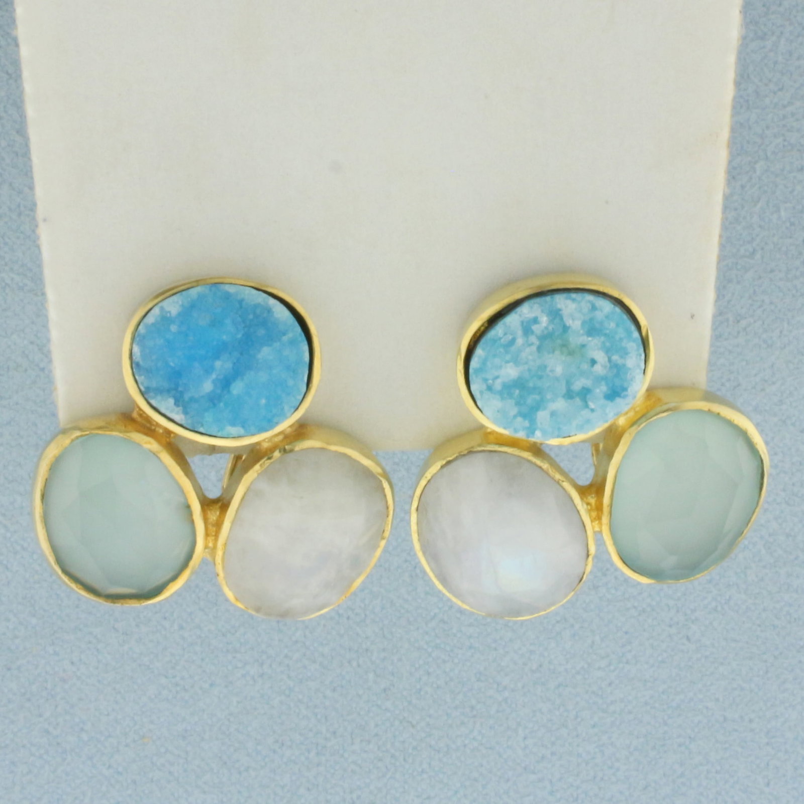 Unique Bezel Set Quartz Statement Earrings in 10k Yellow Gold: In 10k yellow gold. 7/8 inches by 7/8 inches. Contains three unique different quartz gemstones druzy, white, and aqua colored. Omega post backs for pierced ears. 9.4g.