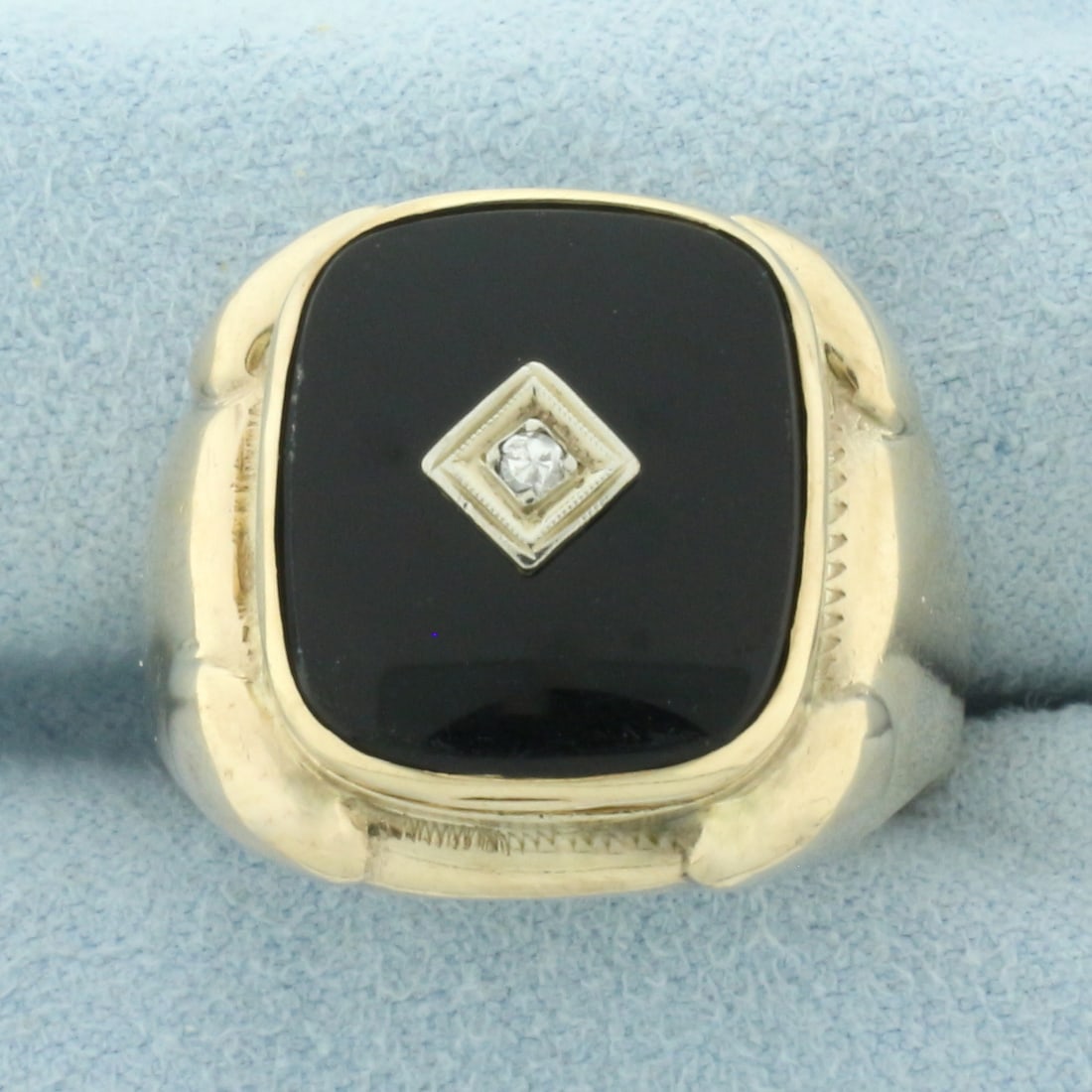 Mens Vintage Onyx and Diamond Ring in 10k Yellow Gold: In 10k yellow gold. 15.5mm by 14mm, onyx plaque. Contains one high quality .02ct diamond, SI clarity/H color. 20mm wide at center. Size: 11.25. 11.3g.