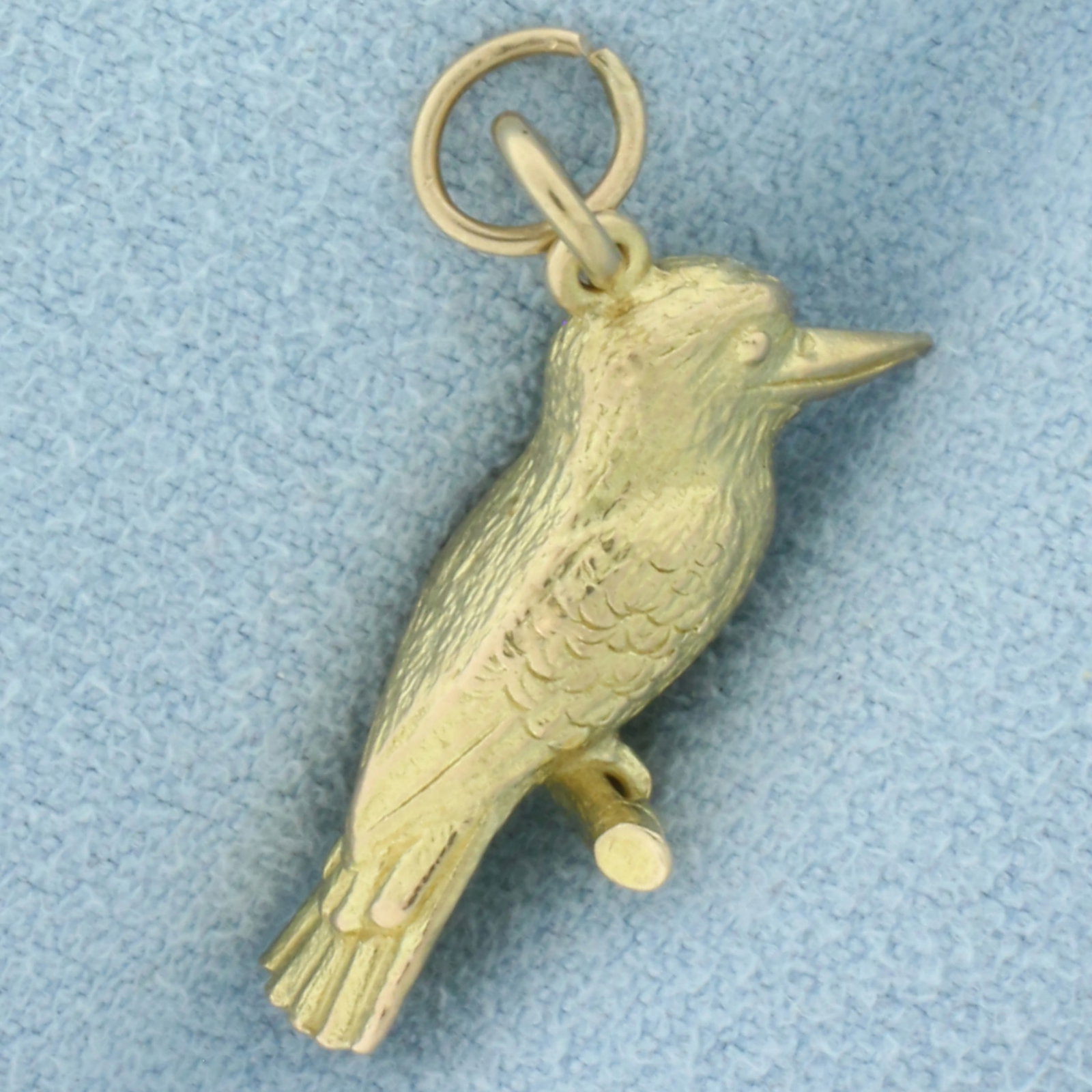 3D Kookaburra Bird Charm in 14k Yellow Gold: In 14k yellow gold. 3D design. 1/2 inch long (including jump ring) by 5/8 inch wide. 4.1g.