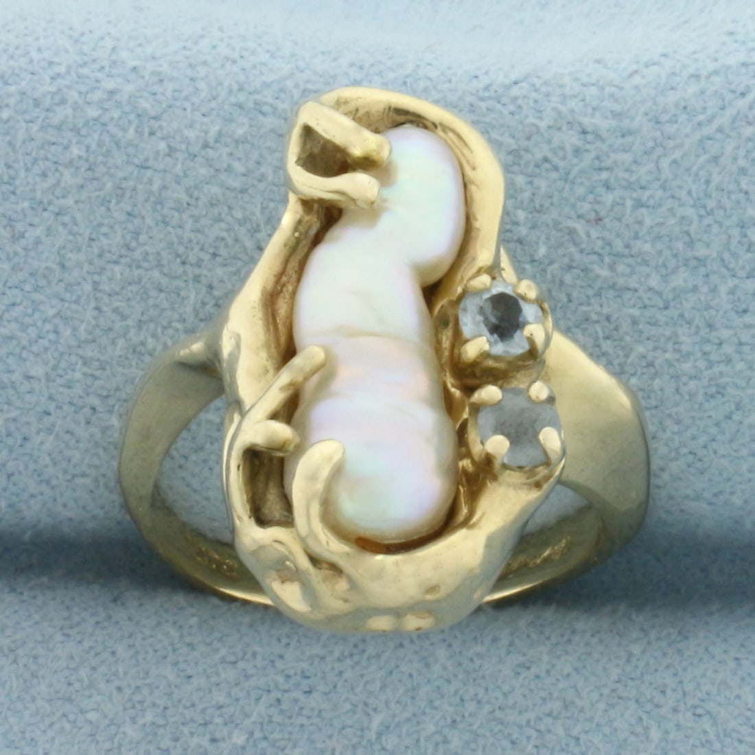 Baroque Pearl and Aquamarine Ring in 14k Yellow Gold: In 14k Yellow Gold. Contains one high quality naturaln16.mm7x6.2mm Baroque Pearl with high luster. Also contains two high quality 3mm Aquamarine gemstones with bright color and excellent clarity. 20mm