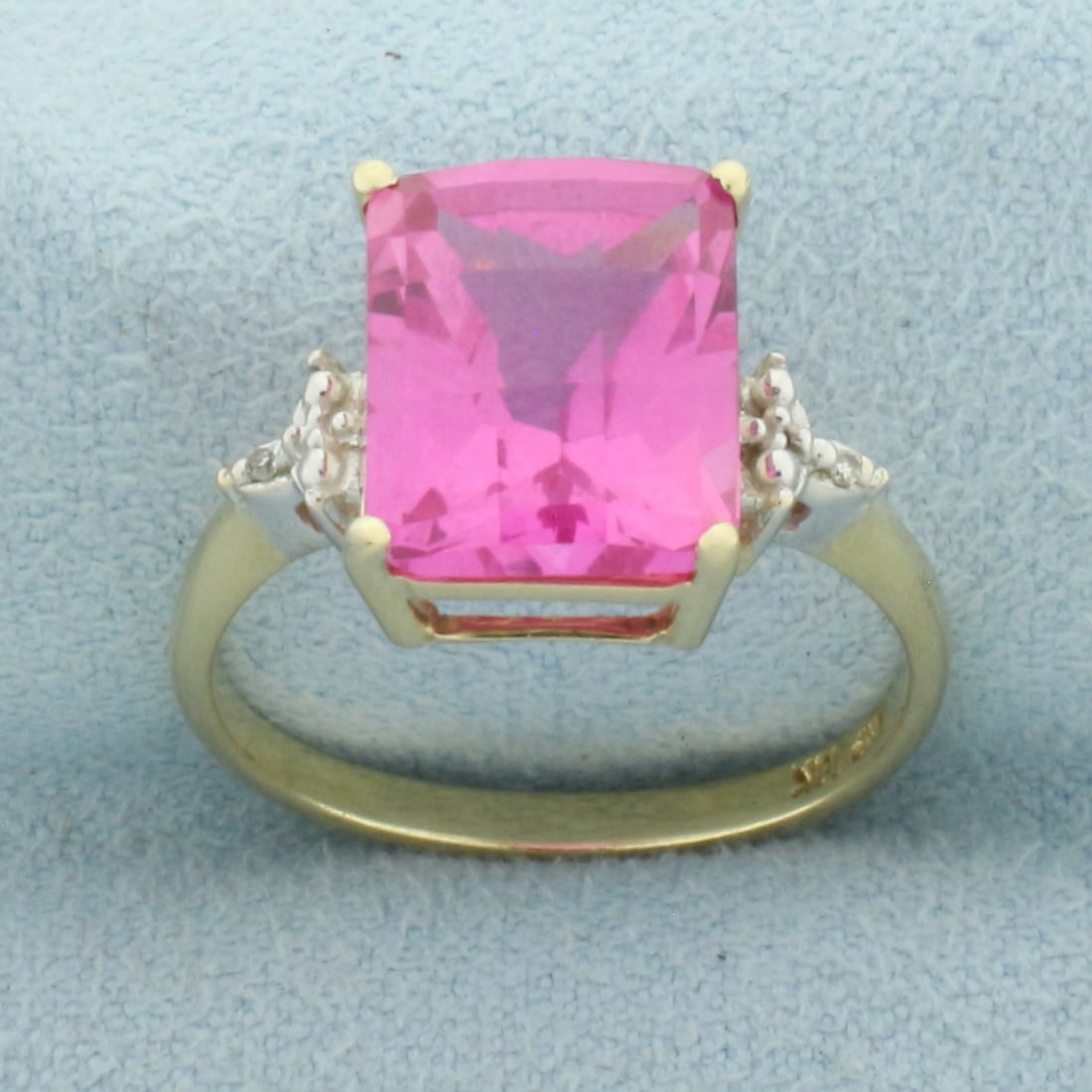 Lab Pink Sapphire and Diamond Ring in 10k Yellow Gold: In 10k Yellow Gold. Contains one 11x9mm high quality fancy checkerboard rectangular cut Lab Pink Sapphire, approximately 6cts, with vibrant color and excellent clarity. Also contains two 1/2pt high qu
