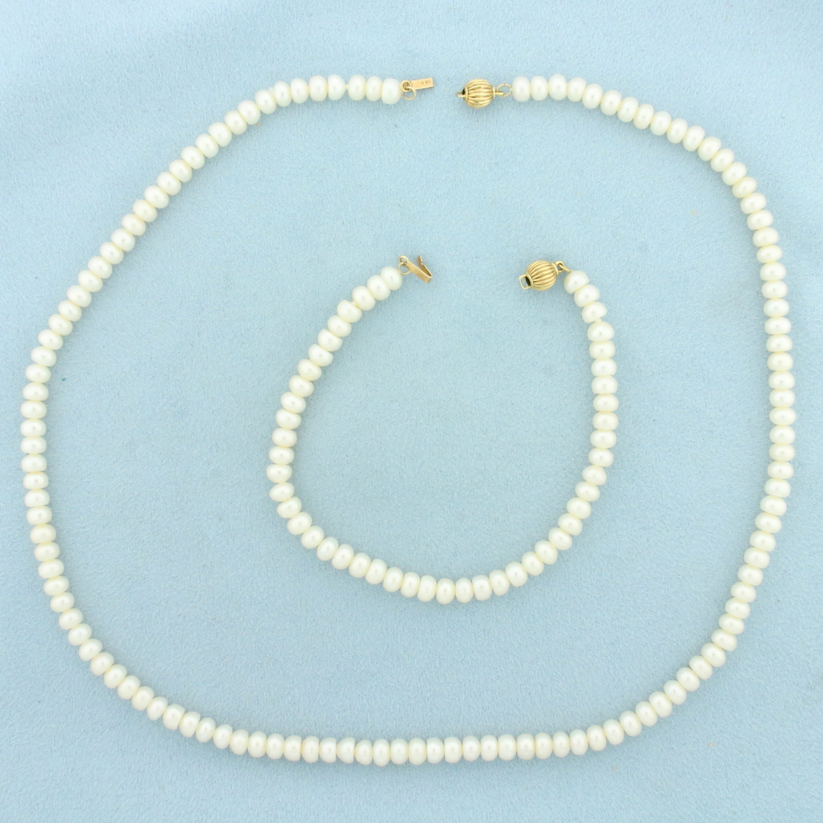 Pearl Necklace Strand and Bracelet Set in 14k Yellow Gold: 14k Yellow Gold clasp. Contains 5mm high quality Freshwater Pearls with high luster and bright white color. Necklace is 18 inches long. Bracelet is 7 1/8 inches long. Decorative locking bead clasp. 26