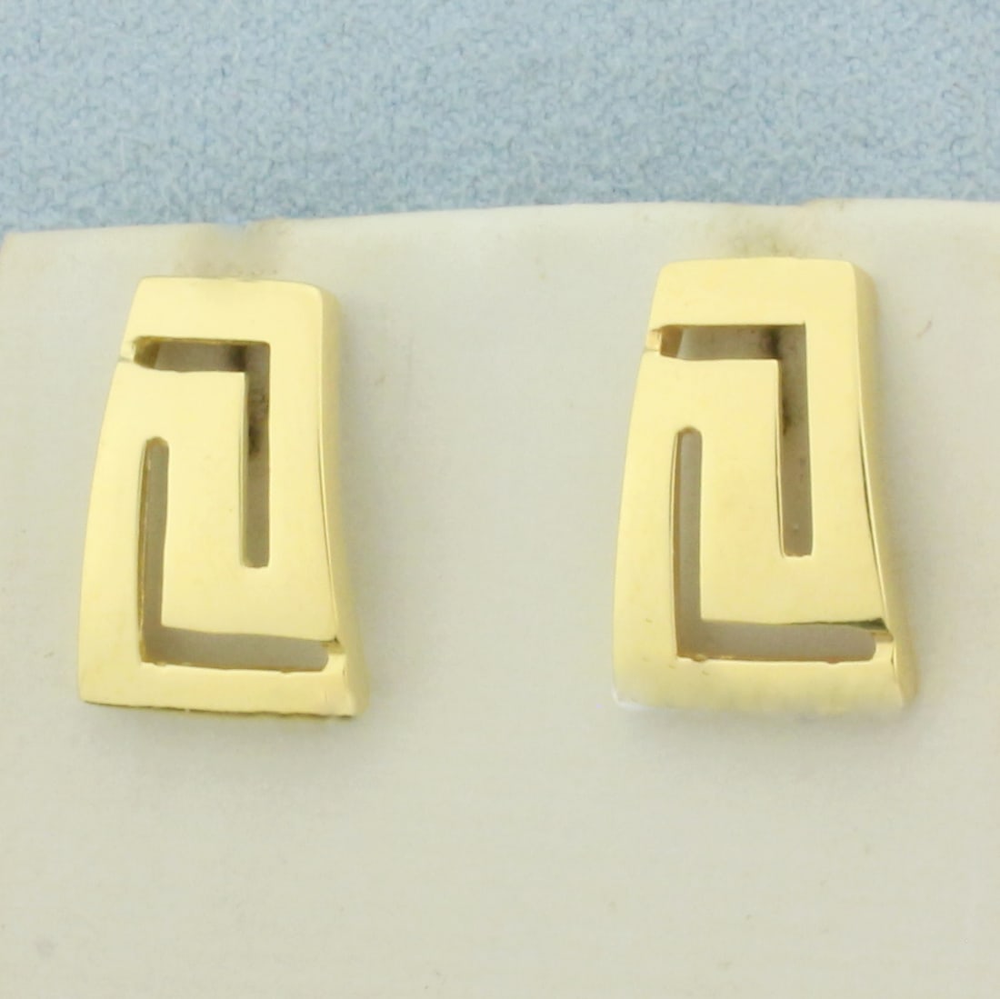 Greek Key Earrings in 18k Yellow Gold: In 14k Yellow Gold. 5/8 inch long. 3/8 inch wide. Friction backs. 4.9g.
