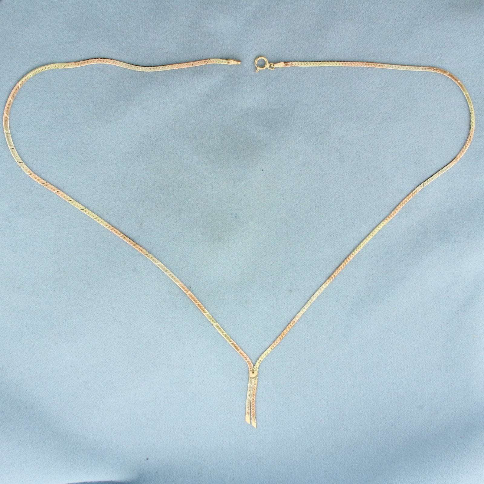 Italian Tri-Color Diamond Cut Herringbone Necklace in 14k Yellow, Rose, and White Gold: In 14k Yellow, Rose, and White Gold. 18 inches long. 1.8mm wide. Italian made. Diamond cut diagonal stripes for added brilliance. Spring clasp. 4.1g.