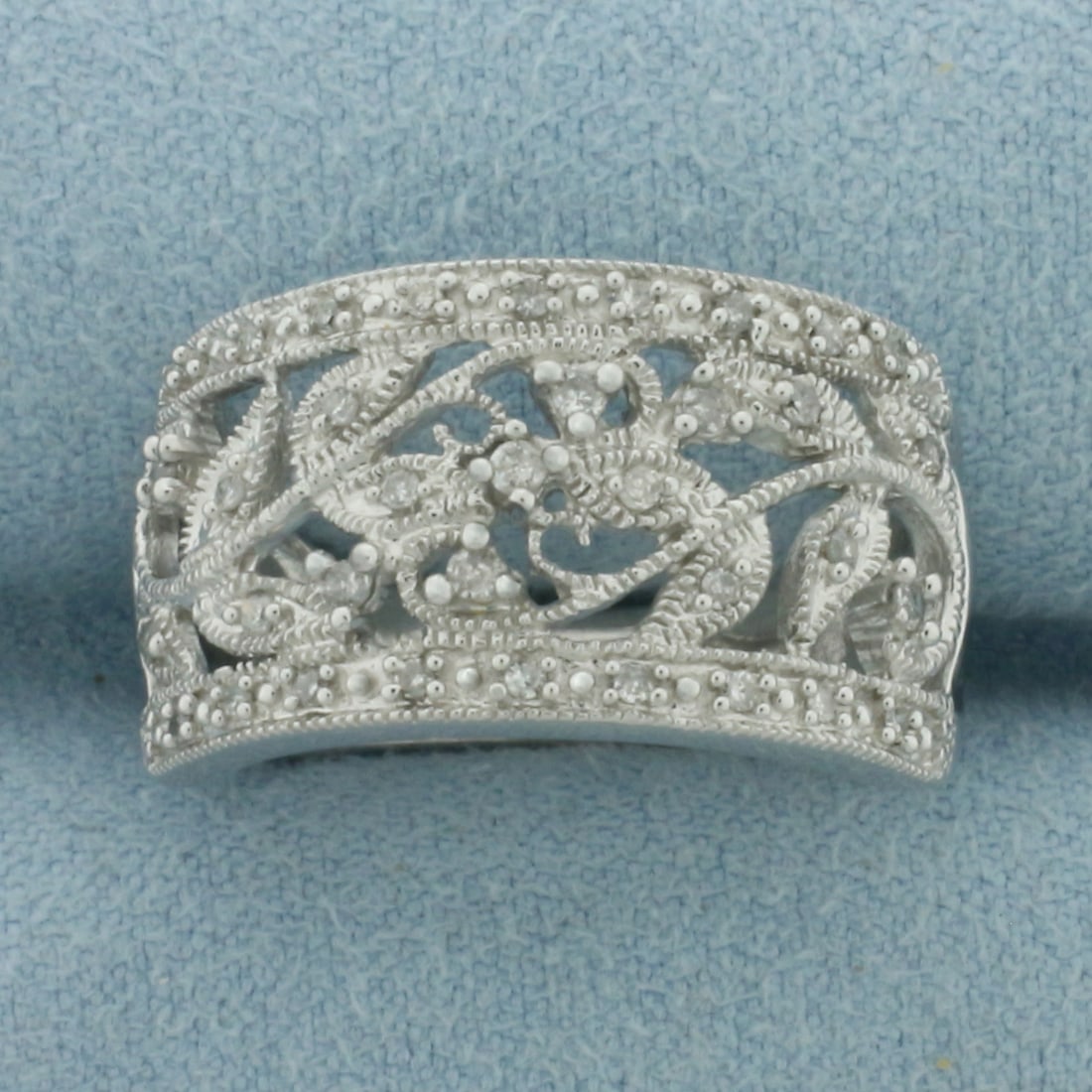 Flower Design Diamond Ring in 10k White Gold: In 10k White Gold. Contains twenty-seven 1/2pt and six .01ct high quality diamonds. 12.2mm wide at top of ring. Size 7.25. 5.6g.