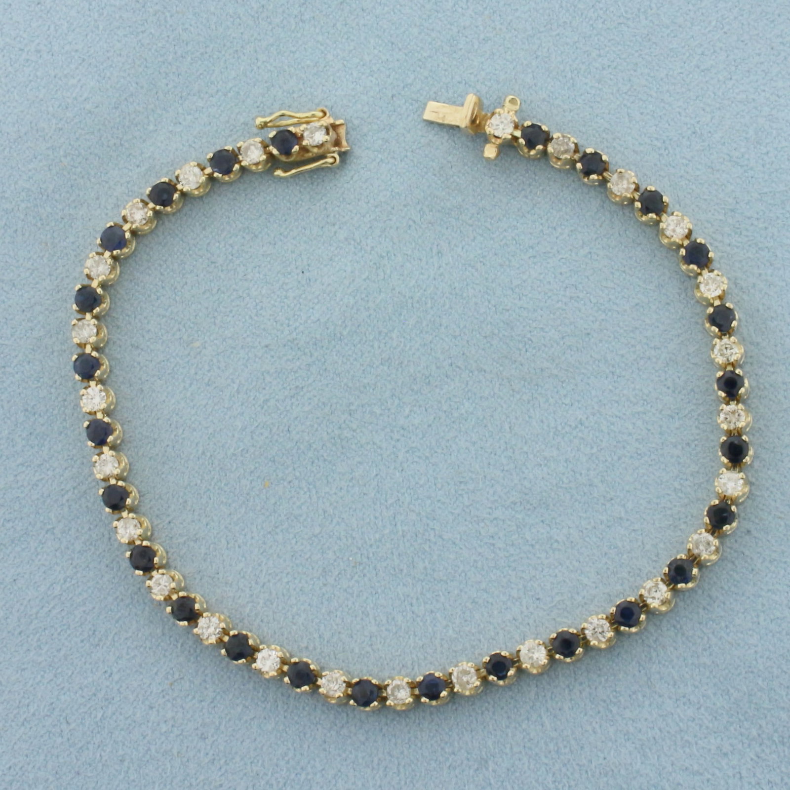 Sapphire and Diamond Tennis Bracelet in 14k Yellow Gold: In 14k Yellow Gold. Contains twenty-six 2.75mm high quality natural Sapphire gemstones, approximately 2ct TW, with intense color and excellent clarity. Also contains twenty-seven high quality diamonds