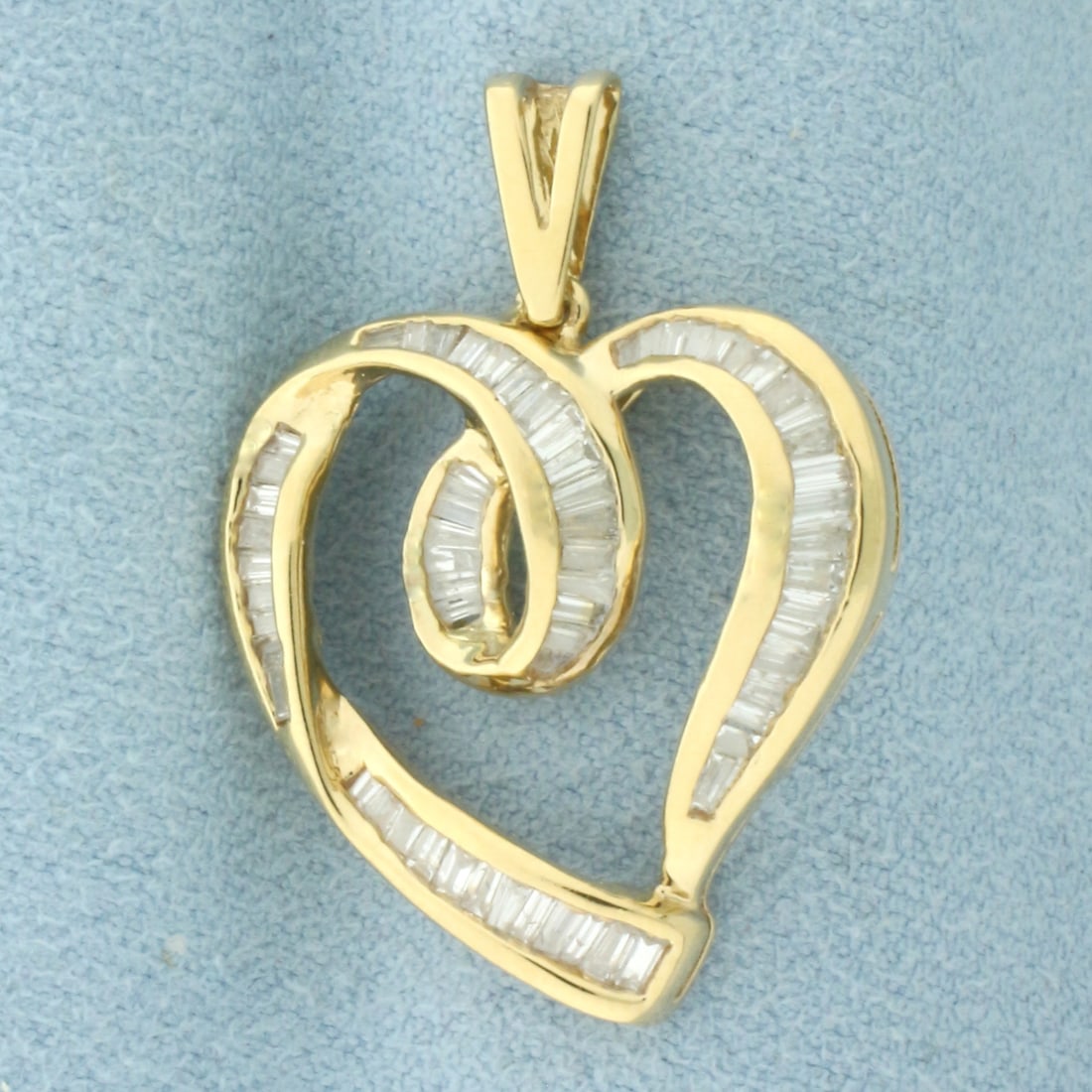 Baguette Diamond Heart Pendant in 14k Yellow Gold: In 14k Yellow Gold. Contains seventy high quality diamonds, approximately 1ct TW, SI1 clarity/G color. 1 1/4 inch long. 7/8 inch wide. 4.2g.