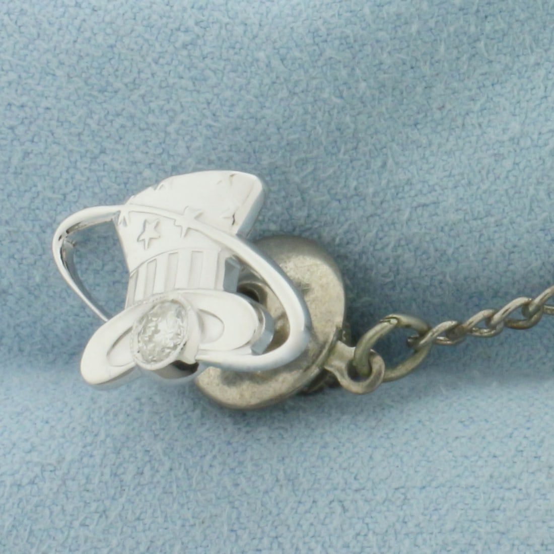 Diamond Eastern Airlines Hat Pin in 10k White Gold: Pin is 10k White Gold, back and chain is gold plated. Contains one 1/5ct high quality diamond. 3/4 inch wide. 1/2 inch tall. 4.5g.