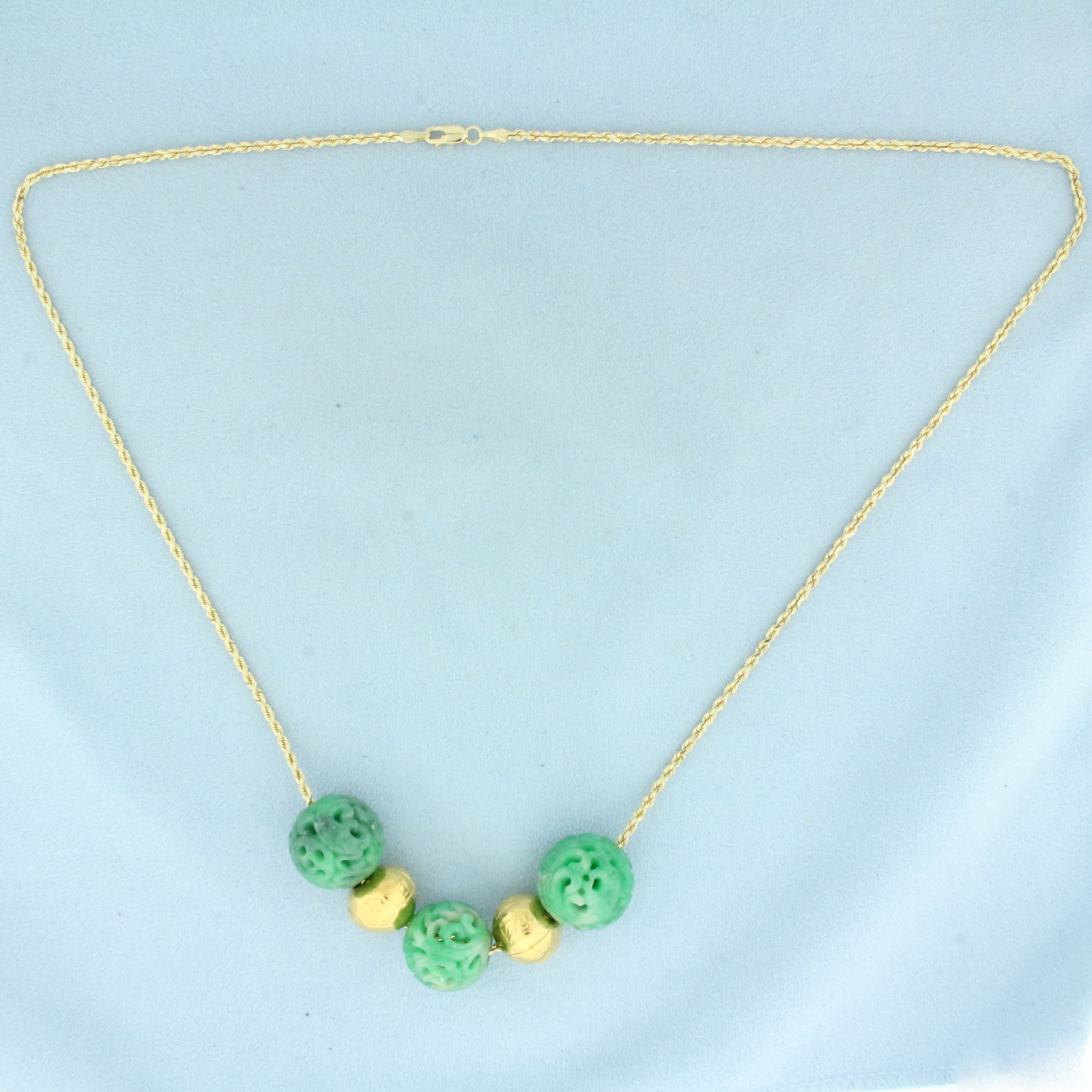 Carved Jade and Gold Bead Necklace in 14k Yellow Gold: In 14k Yellow Gold. Contains three high quality 16.3-17.3mm carved jade beads. Also contains two 13mm embossed gold beads. 22 inch long rope link chain. 1.7mm wide. Lobster clasp. 30.5g.