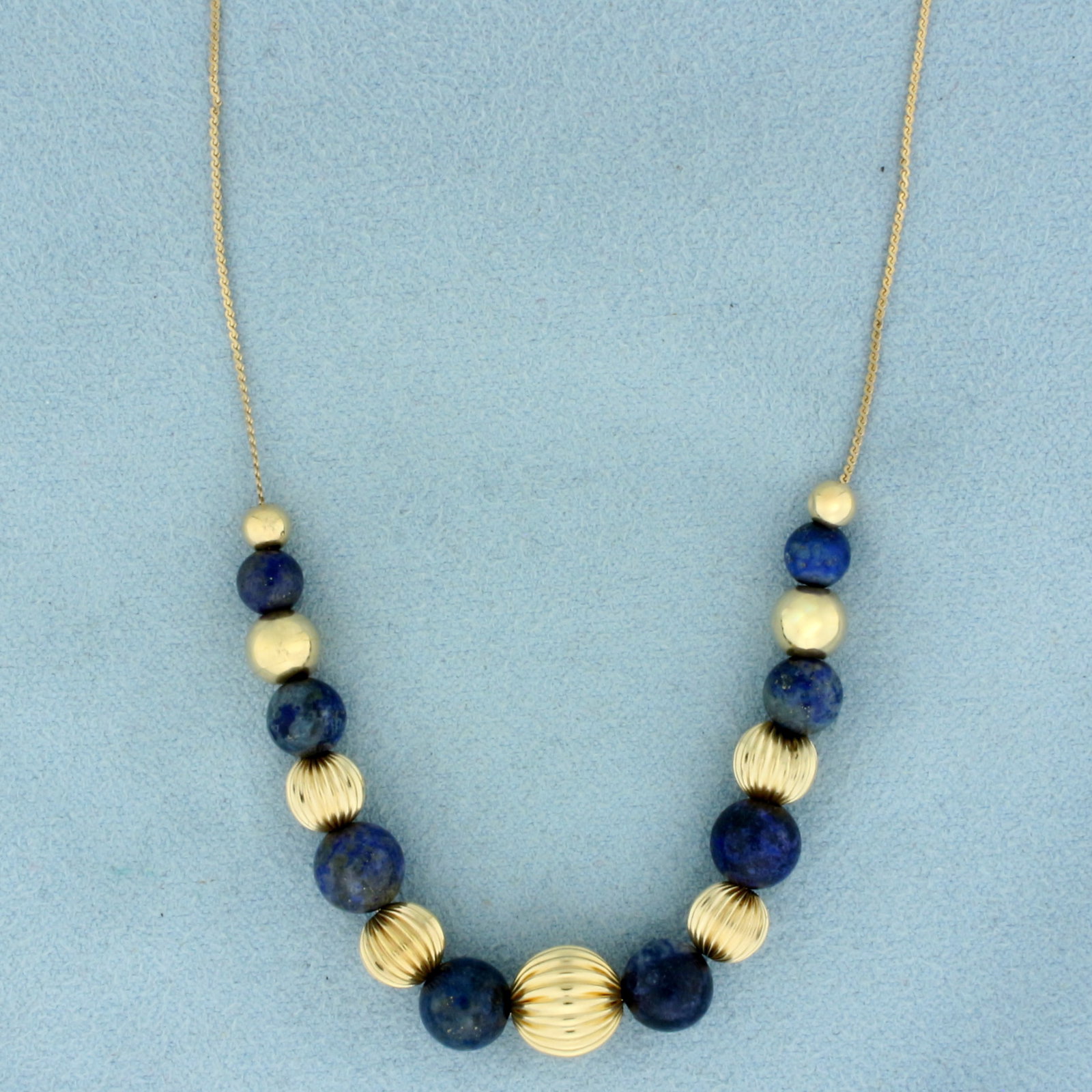 Italian Lapis Lazuli Ball Bead Necklace in 14k Yellow Gold: In 14k Yellow Gold. Contains eight 5 to 7mm high quality Lapis Lazuli beads with deep color and fleks of gold. Also contains nine 4 to 8.5mm high quality gold beads. Serpentine S-link chain is 24 inch