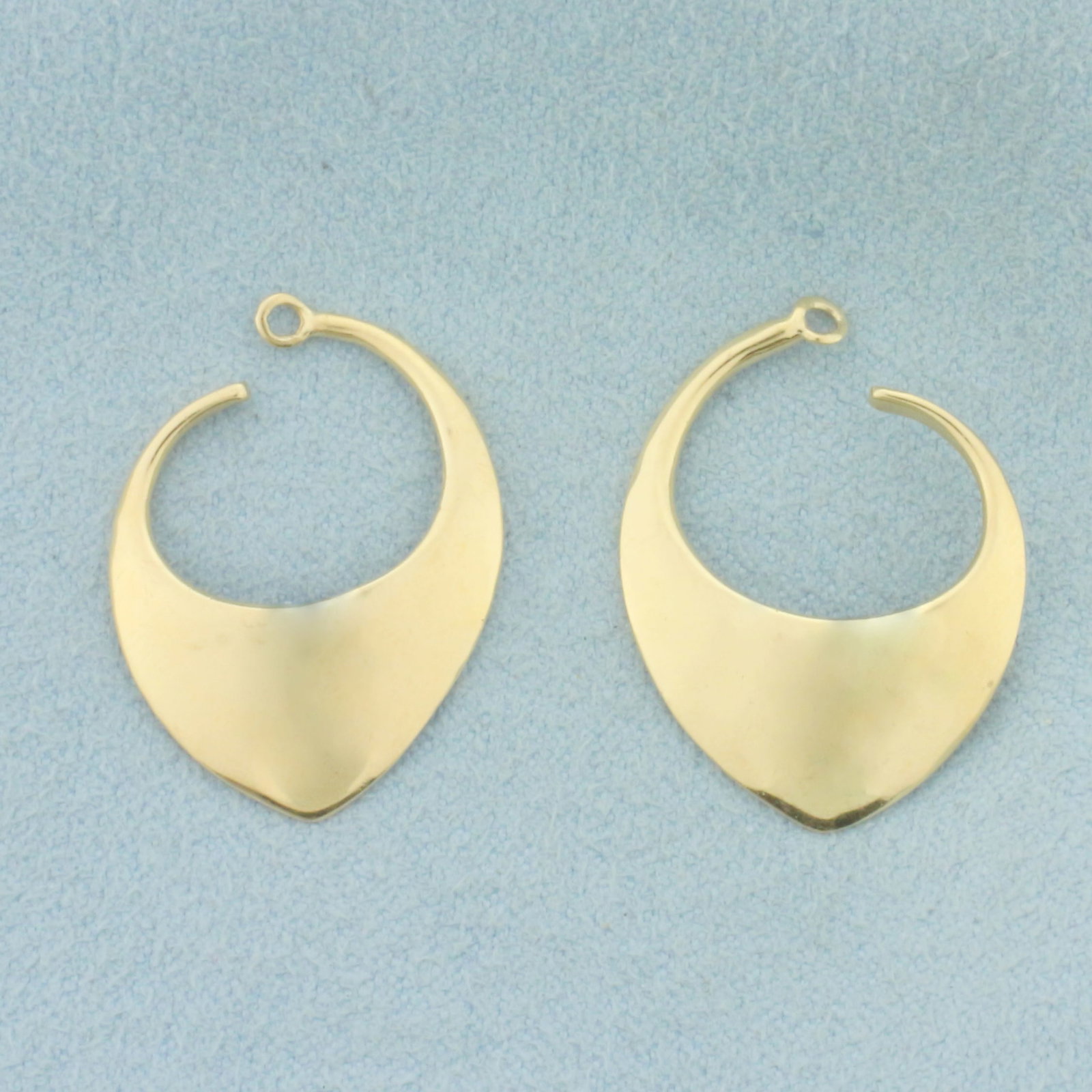 Stud Earring Enhancer Jackets in 14k Yellow Gold: In 14k Yellow Gold. 1 inch long. 3/4 inch wide. Designed to fit around stud earrings for new exciting look. 3.5g.
