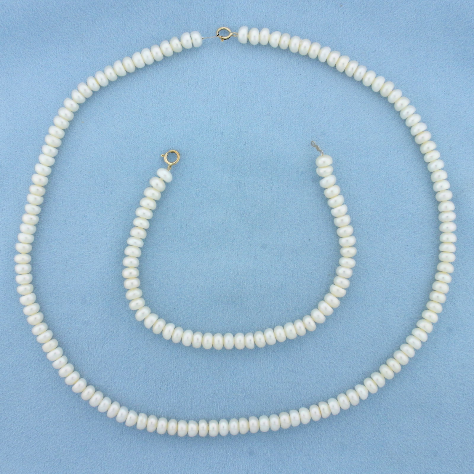 Freshwater Cultured Pearl Necklace and Bracelet Set in 10k Yellow Gold: 10k Yellow Gold clasps. Contains 6mm high quality freshwater pearls with high luster. 18 inches long necklace. 7.5 inches long bracelet. Spring clasp.
